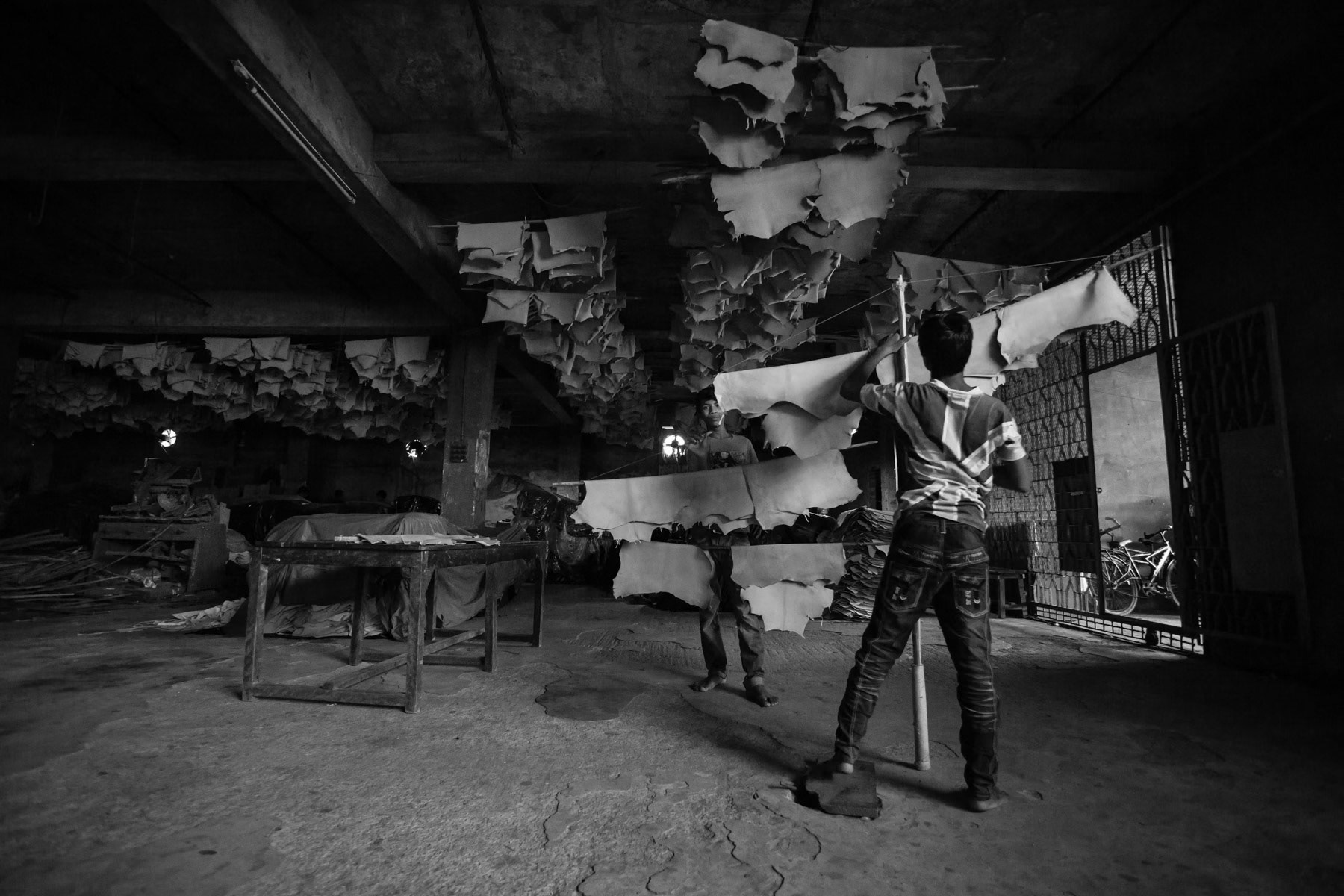 Children working in the skin drying space of the tannery, Hazaribagh, Bangladesh, May 2015