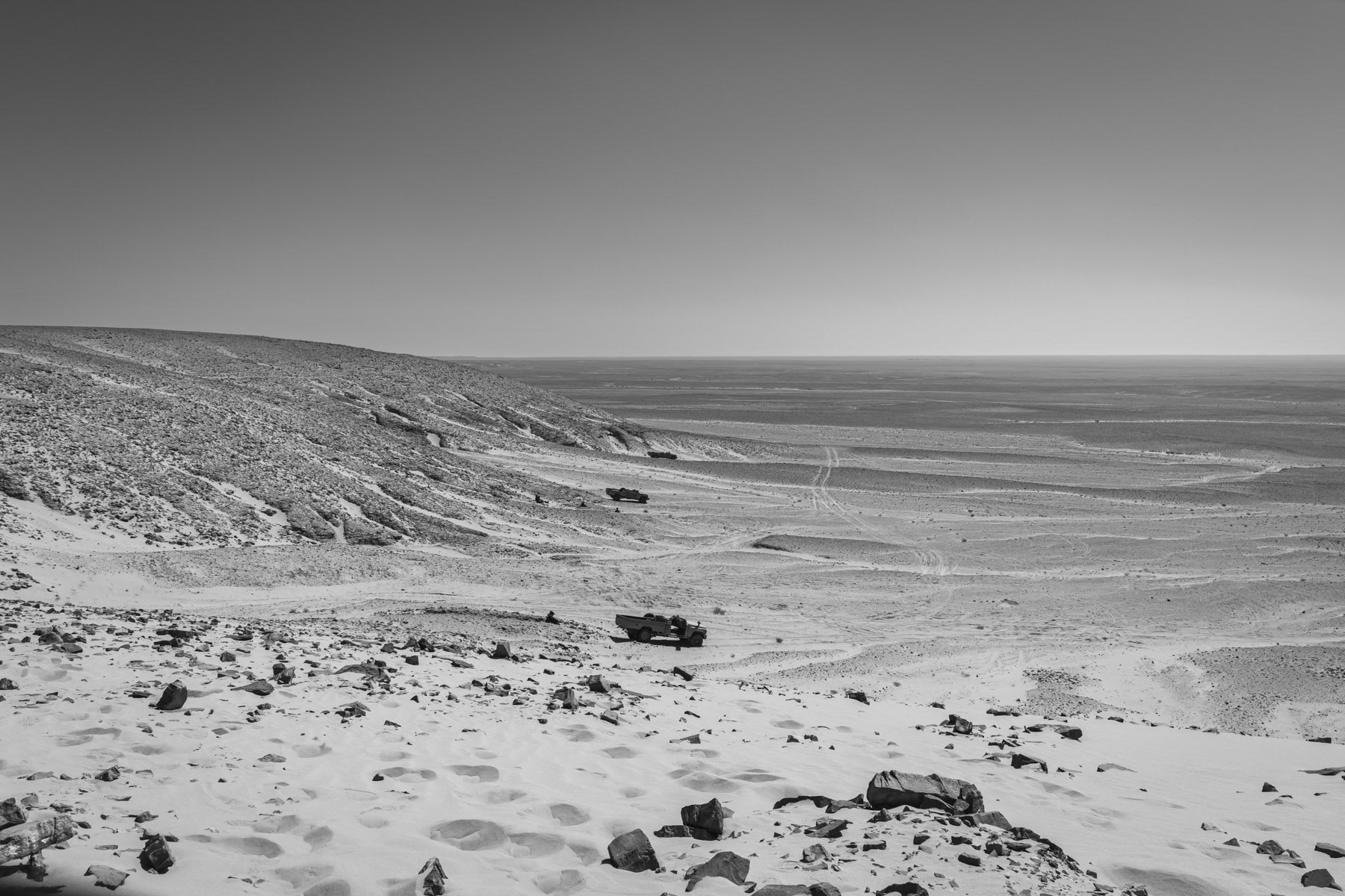 Sahrawi military transport at the frontline with drivers out of their vehicles in case of drone attacks. For the same reasons vehicles have their roof cut out and body parts smeared with mud and sand in order to be less reflective against drone. Undisclosed location in the liberated territories of the Western Sahara, October 2021
