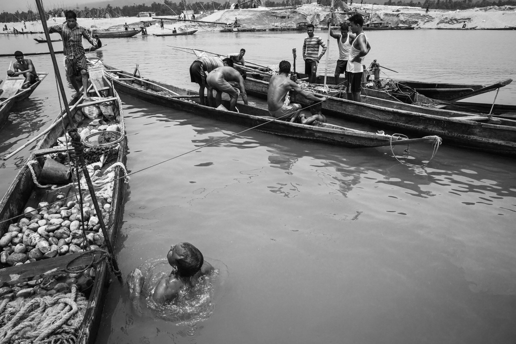 Diver fetching stones at a depth 4 to 8m in the Goyain river near Tamabil, Bangladesh, May 2016
