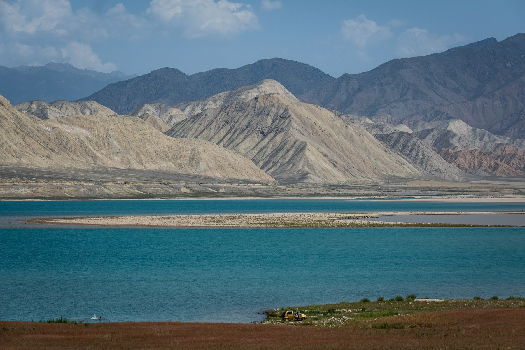 Toktogul Reservoir on the Naryn river showing alarming low levels following persistent droughts in Central Asia. The hydro electrical power stations on the Naryn river and the Toktogul reservoir are crucial for Kyrgyzstan's energy needs, but with longer and recurring periods of drought it becomes impossible to cater for an ever increasing population. The Naryn river, which in Uzbekistan will become the Syr Daria river and eventually flow into the Aral Sea, has an ever decreasing volume. Further accelerating the complete disappearance of the Aral Sea few thousand km away. Toktogul Reservoir, Kara Kul, Jalalabad region, Kyrgyzstan, August 2021
