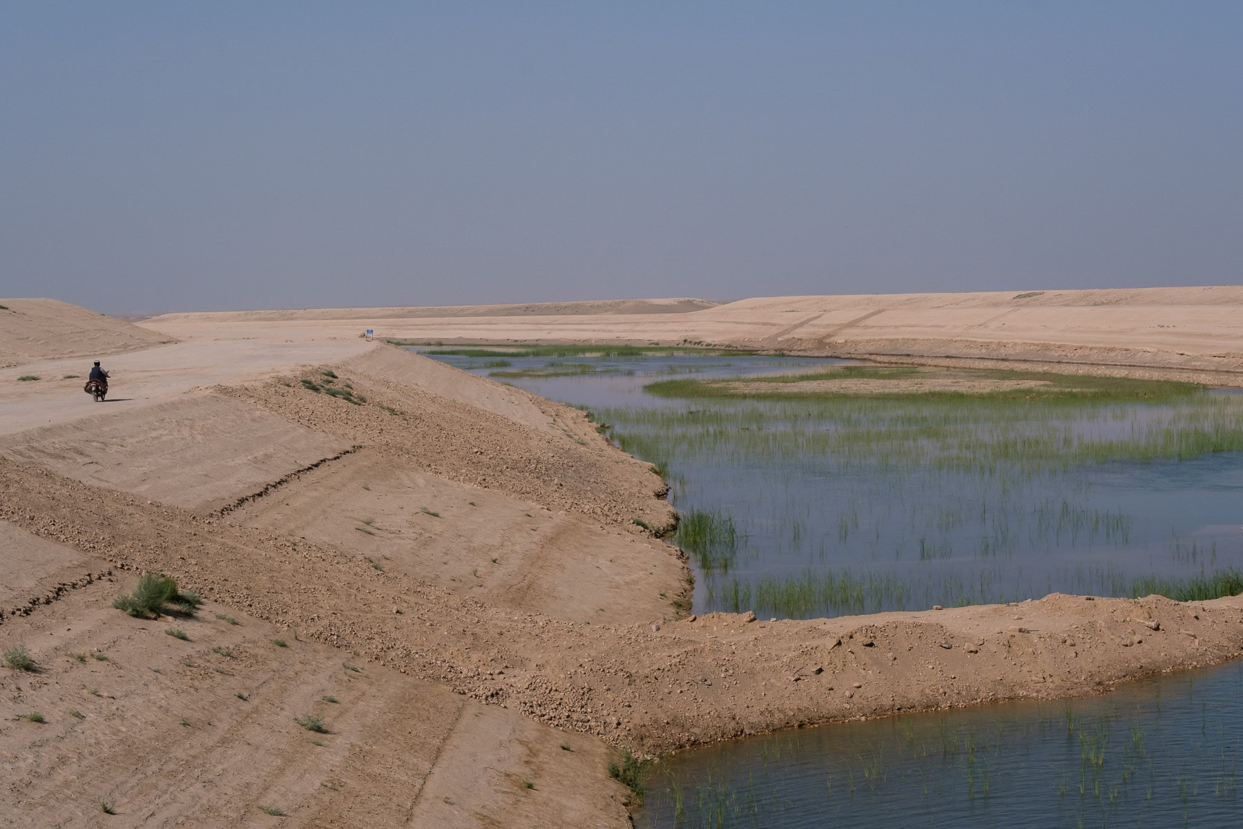 Part of a new irrigation canal being dug in the northern Afghan desert deviated from the Amu Darya river. When completed this controversial project is likely to reduce the flow of the Amu Darya and jeopardize cotton plantations in Uzbekistan and further dry out the Aral Sea which has been all but already cut off from the Amu Darya river. Hairatan near the border with Uzbekistan, Afghanistan, September 2024