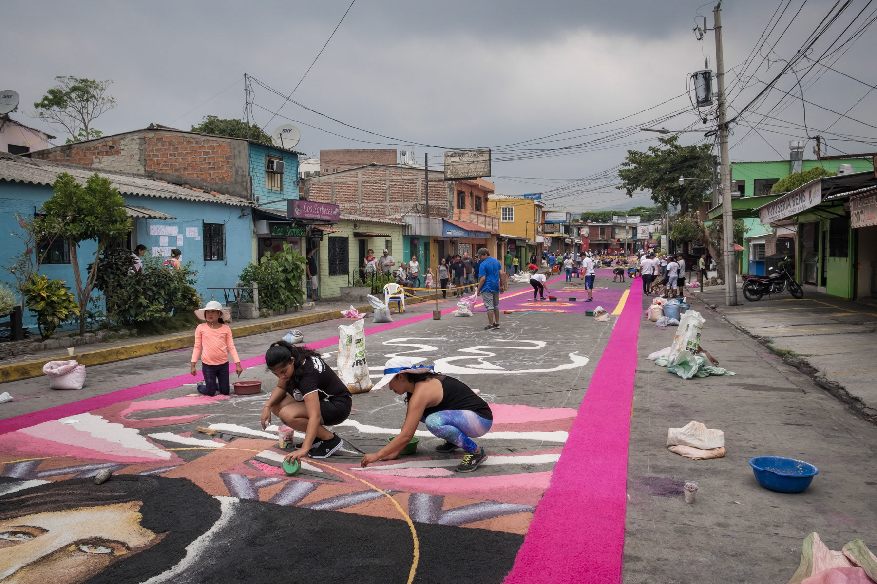 Easter preparations, where enire streets are covered with religious figures and symbols made with coulored salt. The path of salt will guide the people to the church on Easter day. Antiguo Cuscatlan, San Salvador, El Salvador, April 2019