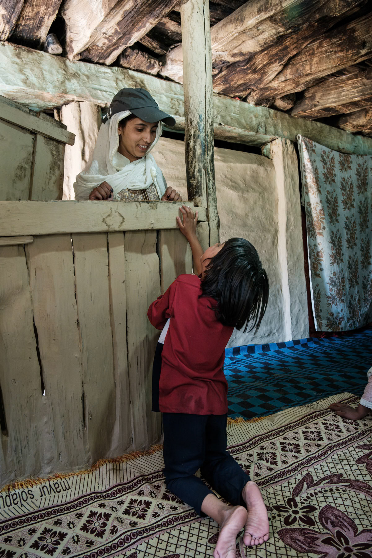 Mother and her daughter in a summer shelter used by shepherd families during the summer months. Naranaag mountains in Kashmir, India, September 2023