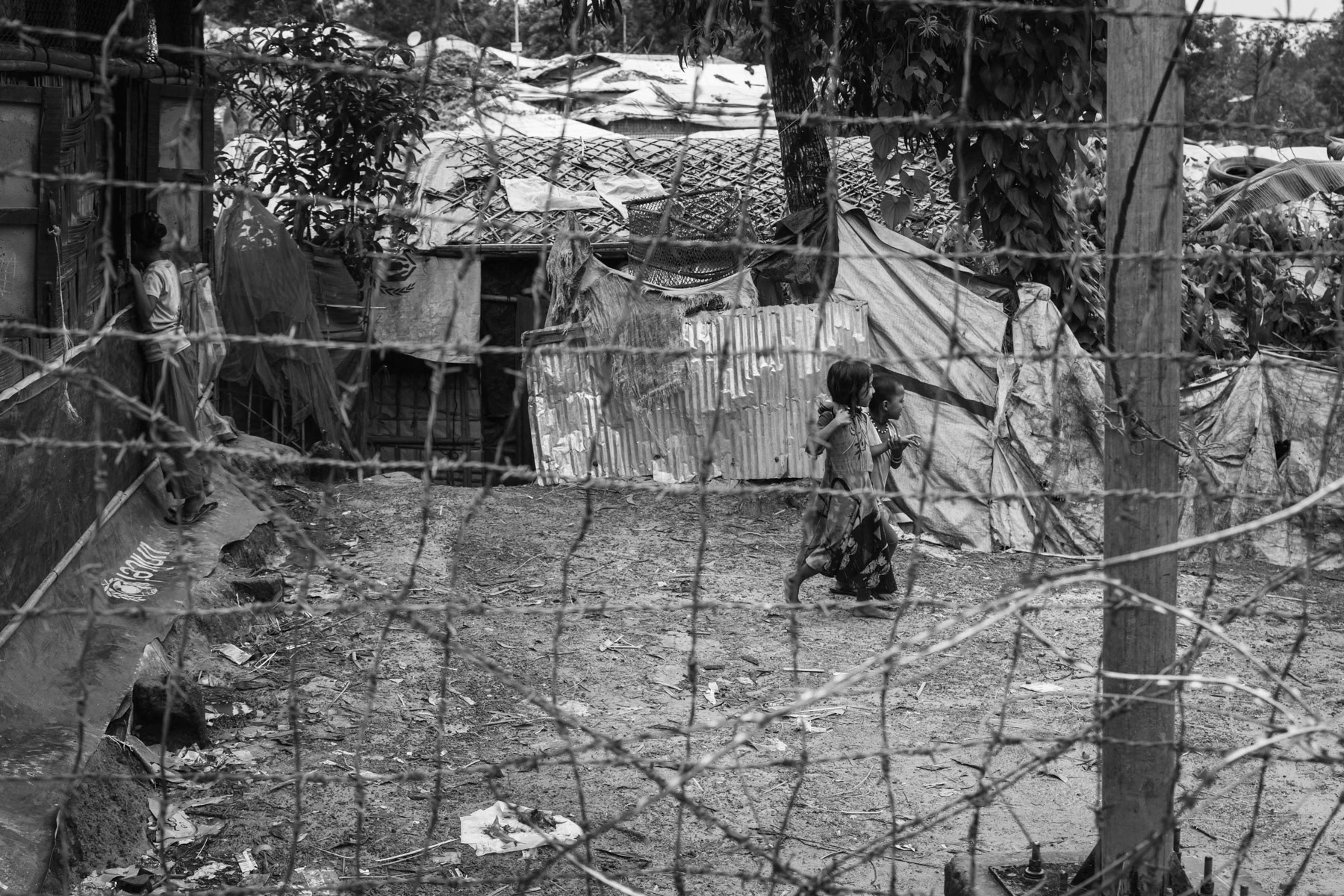 Fences, barbed wire and watch towers are surrounding the refugee camps making it very hard to reach clinics, stores and commodities located outside the camps. After living for more than 5 years in limbo it is very unreal to see any perspective of returning to their homeland or being re-settled in a third country for the growing population of over one million Rohingya refugees. Kutupalong refugee camp, Cox's Bazar, Bangladesh, September 2022
