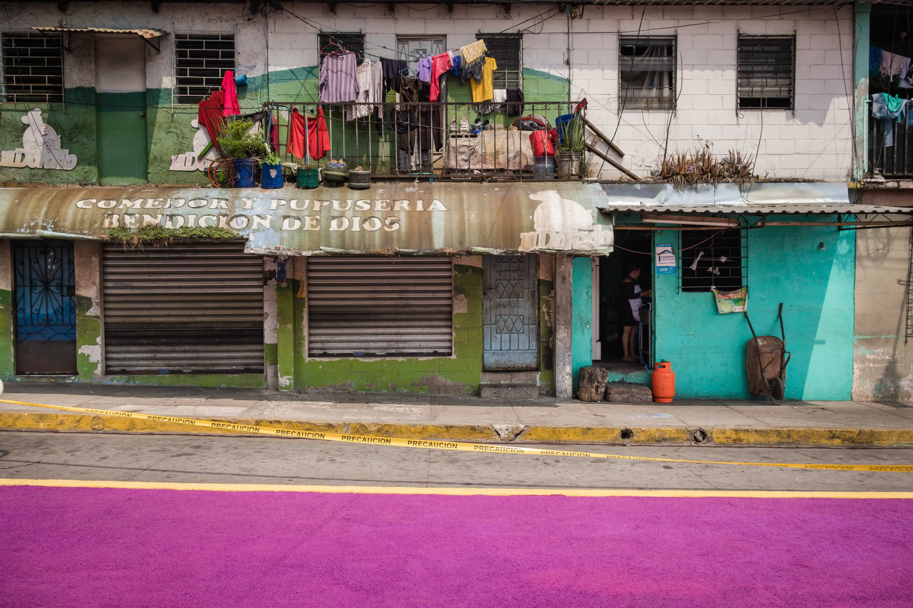 Easter preparations, where enire streets are covered with religious figures and symbols made with coulored salt. The path of salt will guide the people to the church on Easter day. Antiguo Cuscatlan, San Salvador, El Salvador, April 2019