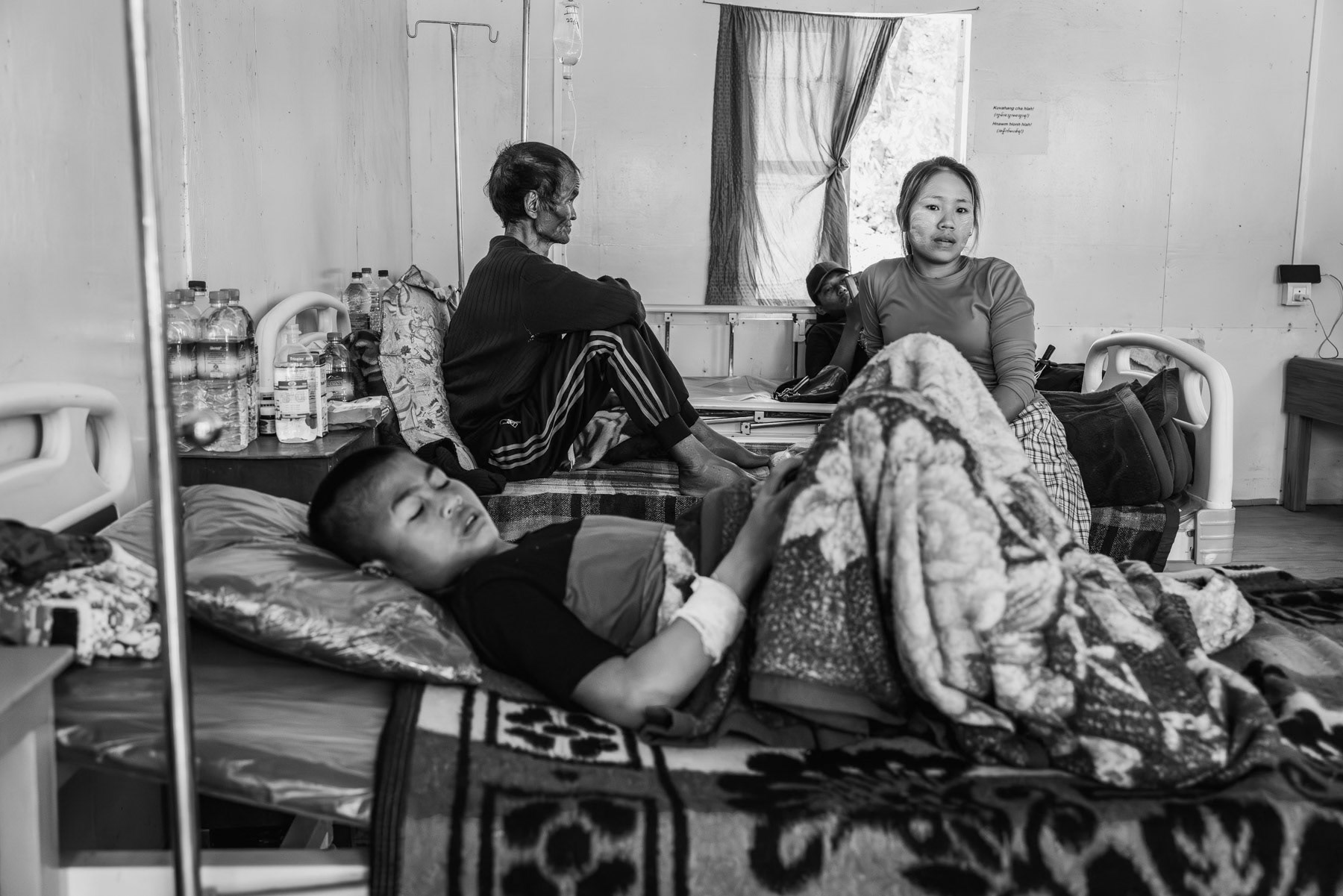 Inpatient ward of the Chin National Army (CNA) military hospital. Civilians and soldiers are being treated in what is now the largest operational hospital in Chin controlled territory. Camp Victoria in Chinlung, Chin State, Myanmar, April 2024