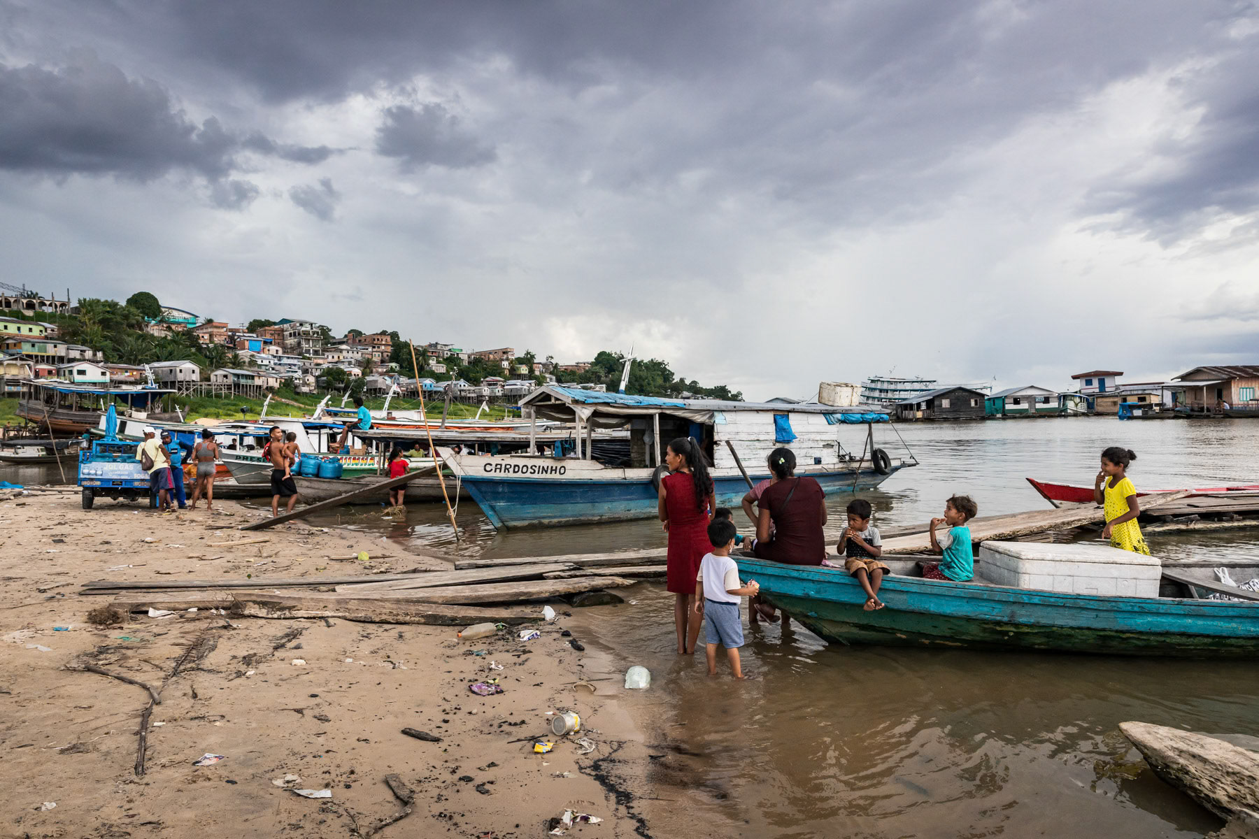 People from nearby villages returning home by boat with supplies bought in the city. The Tefé river is a tributary of the Amazon. Before merging into the Amazon it forms a lake in the city of Tefé. Tefé and its surrounding vast area are only reachable by boat or airplane, no road network reach the area keeping, it protected from major agro industrial and deforestation projects. Tefé, Amazonas state, Brazil, October 2020