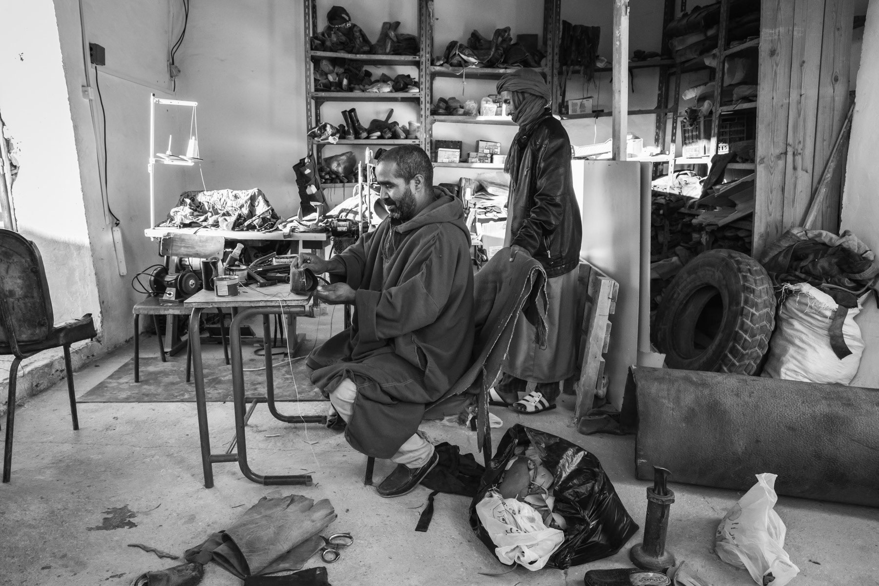 A shoemaker in his workshop in Smara. Because of the extreme isolation of the refugee camps it is very difficult to procure needed materials, but enhancing recycling habits. Smara Saharawi refugee camp Tindouf, Algeria, December 2019
