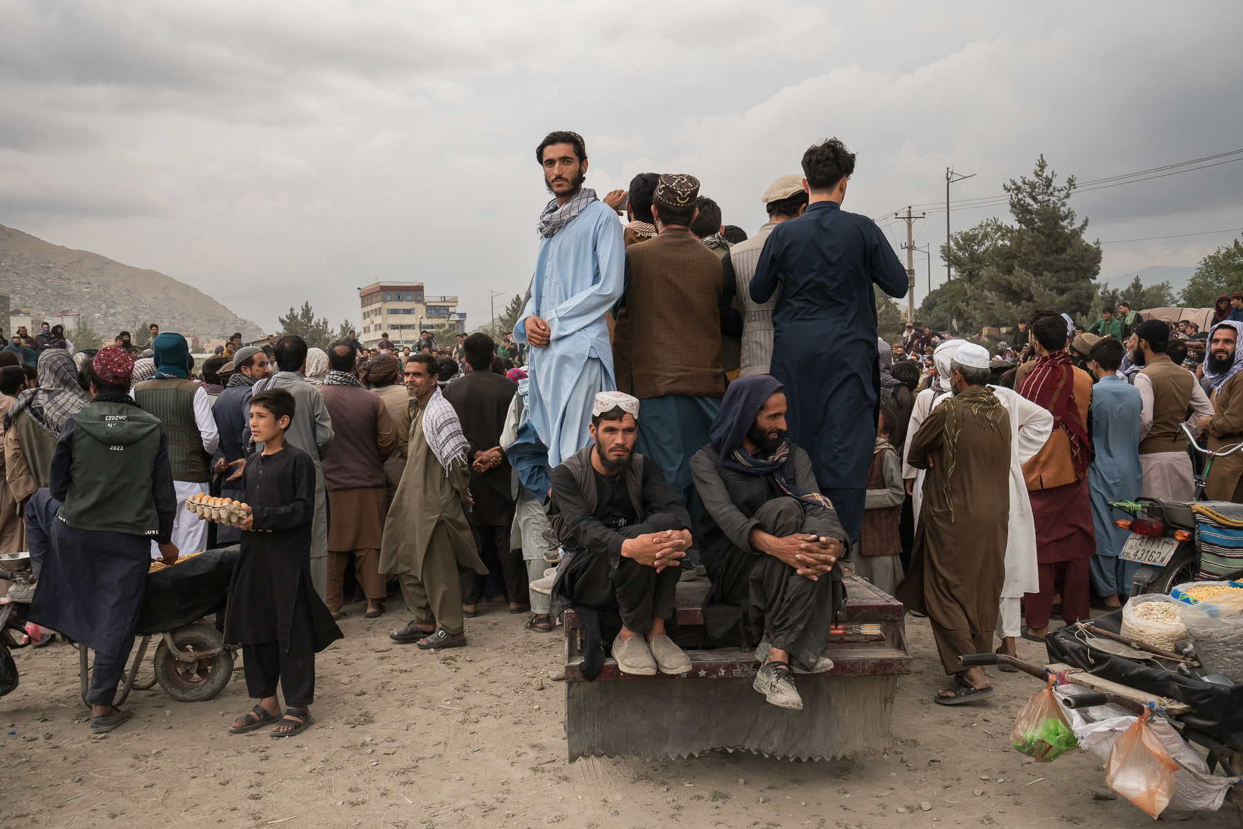 Afghan men attending wrestling games on a friday afternoon. Other games and leisure activities are available at this huge park in downtown Kabul, but only for boys and men as girls and women are banned from visiting public venues. Since taking over Afghanistan in 2021, the Taliban have relentlessly restricted women from being part of society by banning education, work and cultural activities. A de facto 'Nowomenland' and apartheid is being established. Chaman Hozori park, Kabul, Afghanistan, August 2024