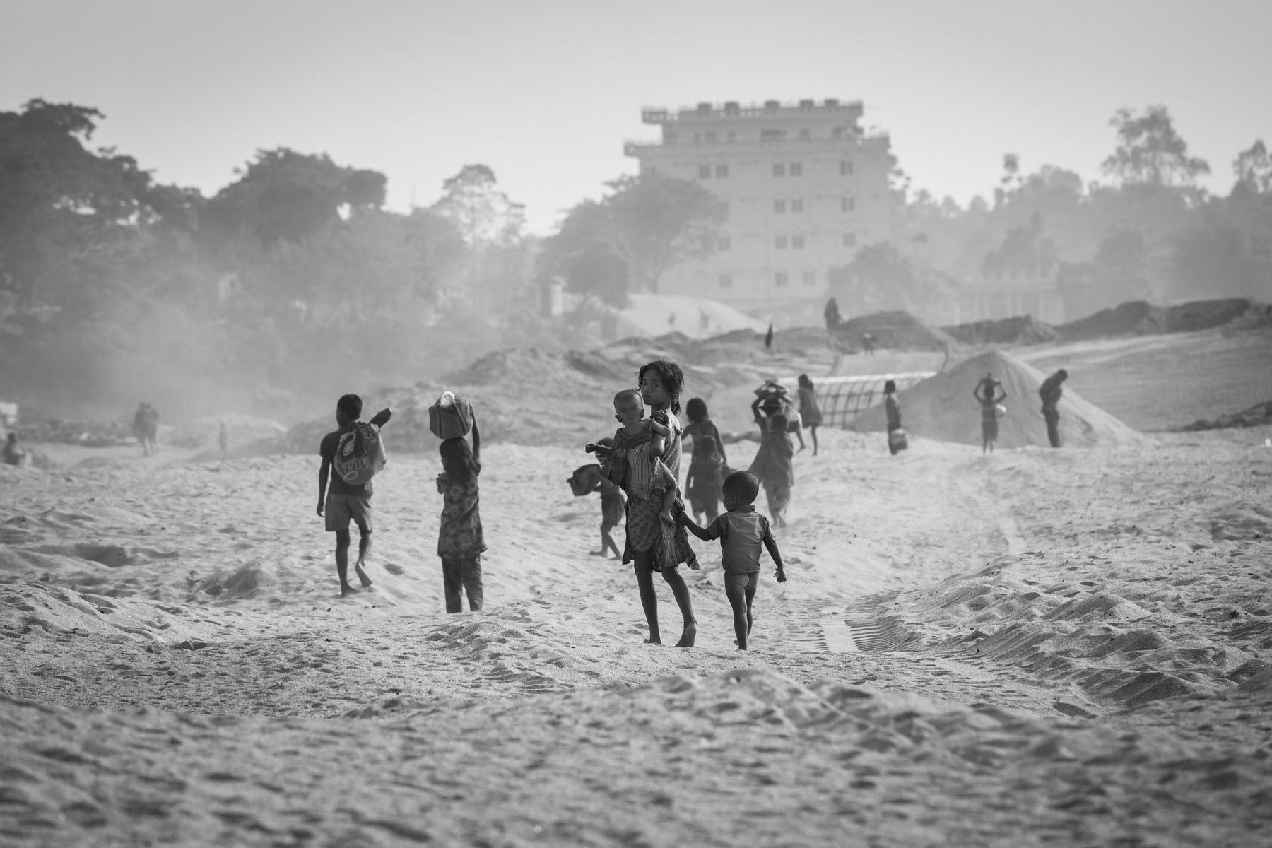 Children going to their makeshift shelters after a day in the riverstone extraction sites of Jaflong, Bangladesh, December 2015
