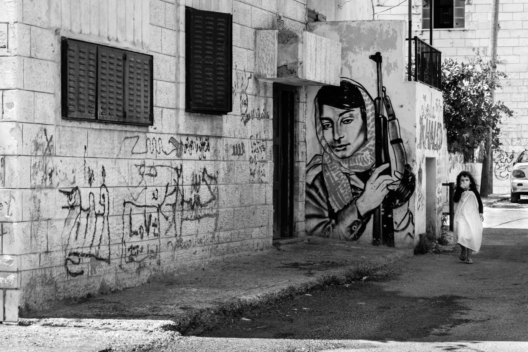 Palestinian girl walking through Aida refugee camp, Bethlehem, Palestine, July 2013