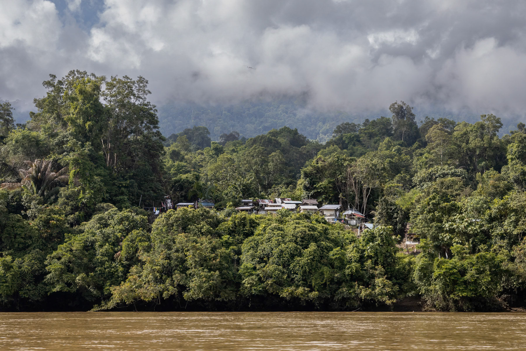 Cemetary on the other side off the river, across the village. Local indigenous tribes with Pagan roots locate the cemetaries always across rivers so that ghosts of the dead would not be able to cross and as such stay where nobody lives. The indigenous population was converted to Christianism only during the mid 20th century, but kept numerous Pagan traditons. Rajang river communities, Belaga, Sarawak in Borneo, June 2022
