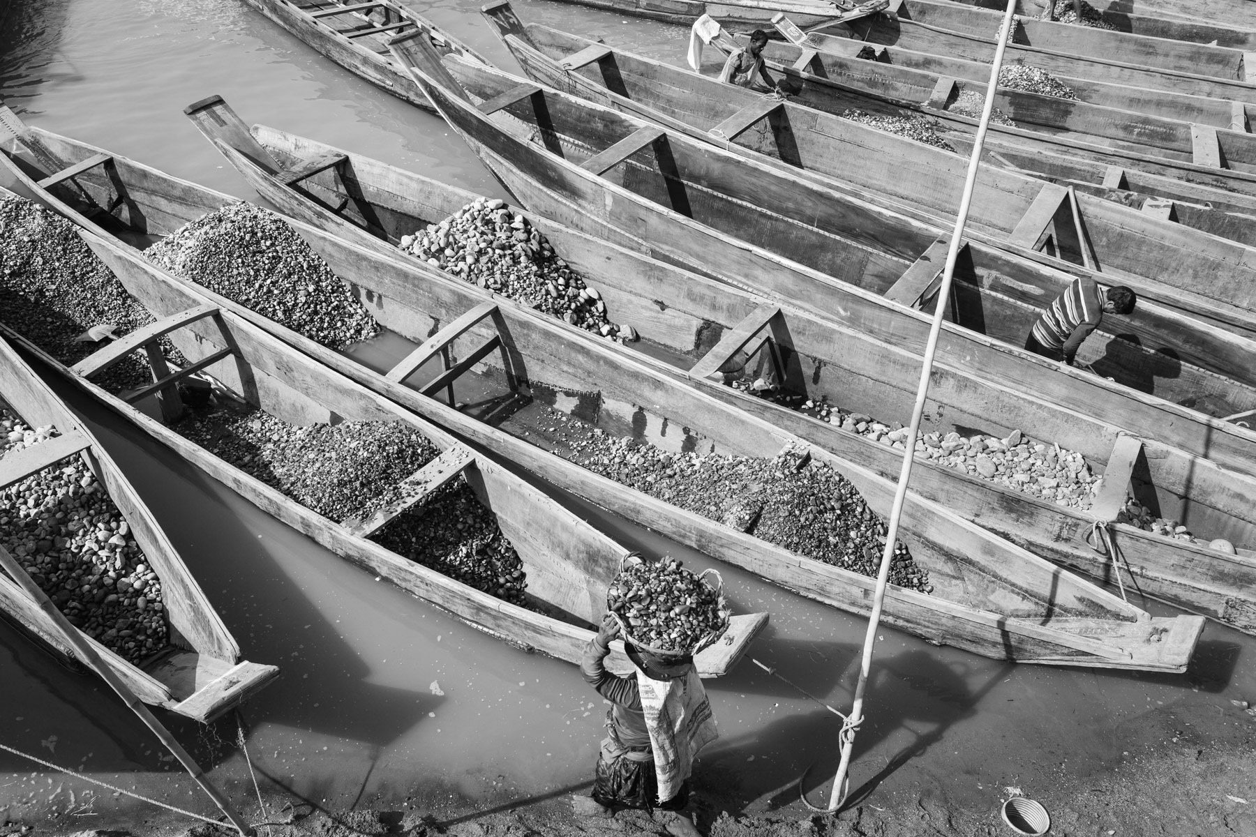 Boats used to move extracted stones down the river, Bholaganj, Bangladesh, December 2015