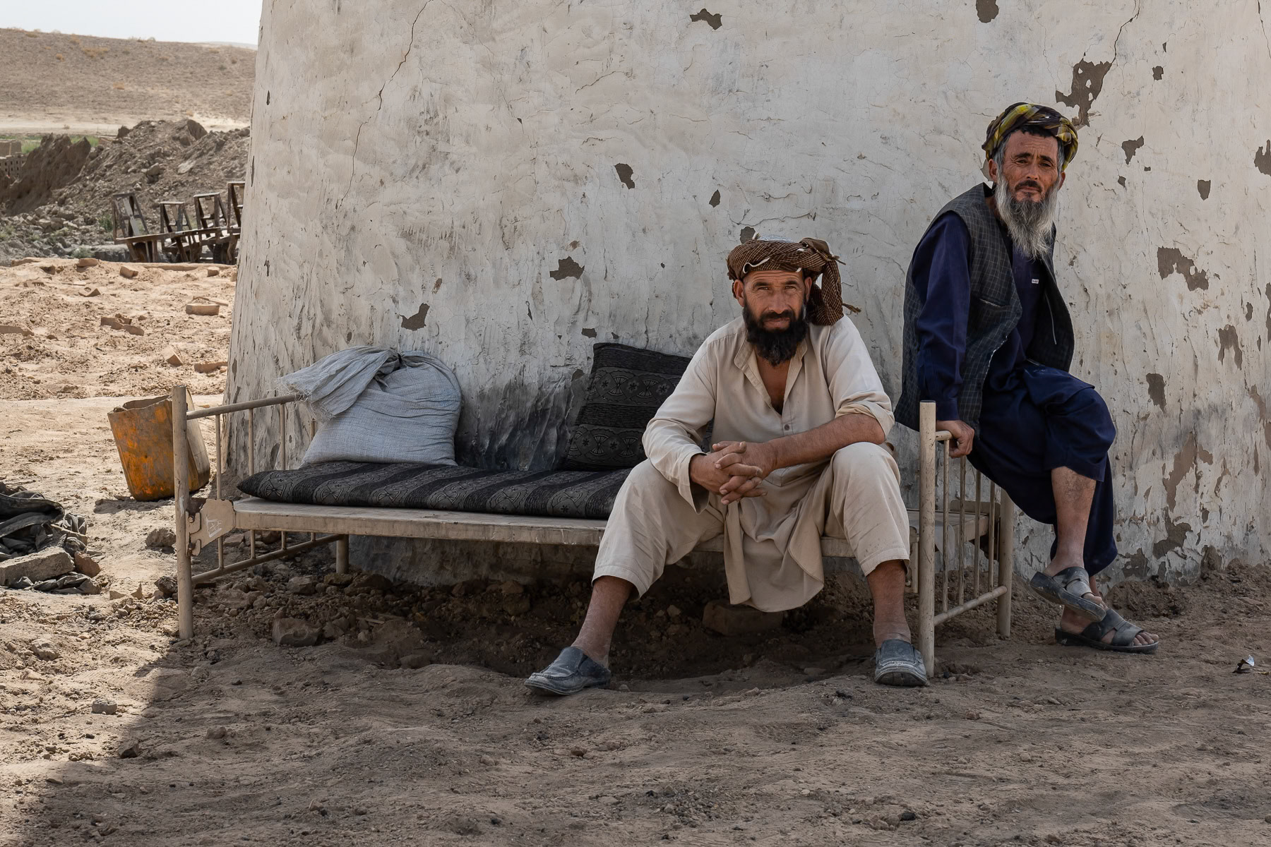 Afghan men supervising the operation of a brick kiln in the Sulgara Valley, Balkh, September 2024