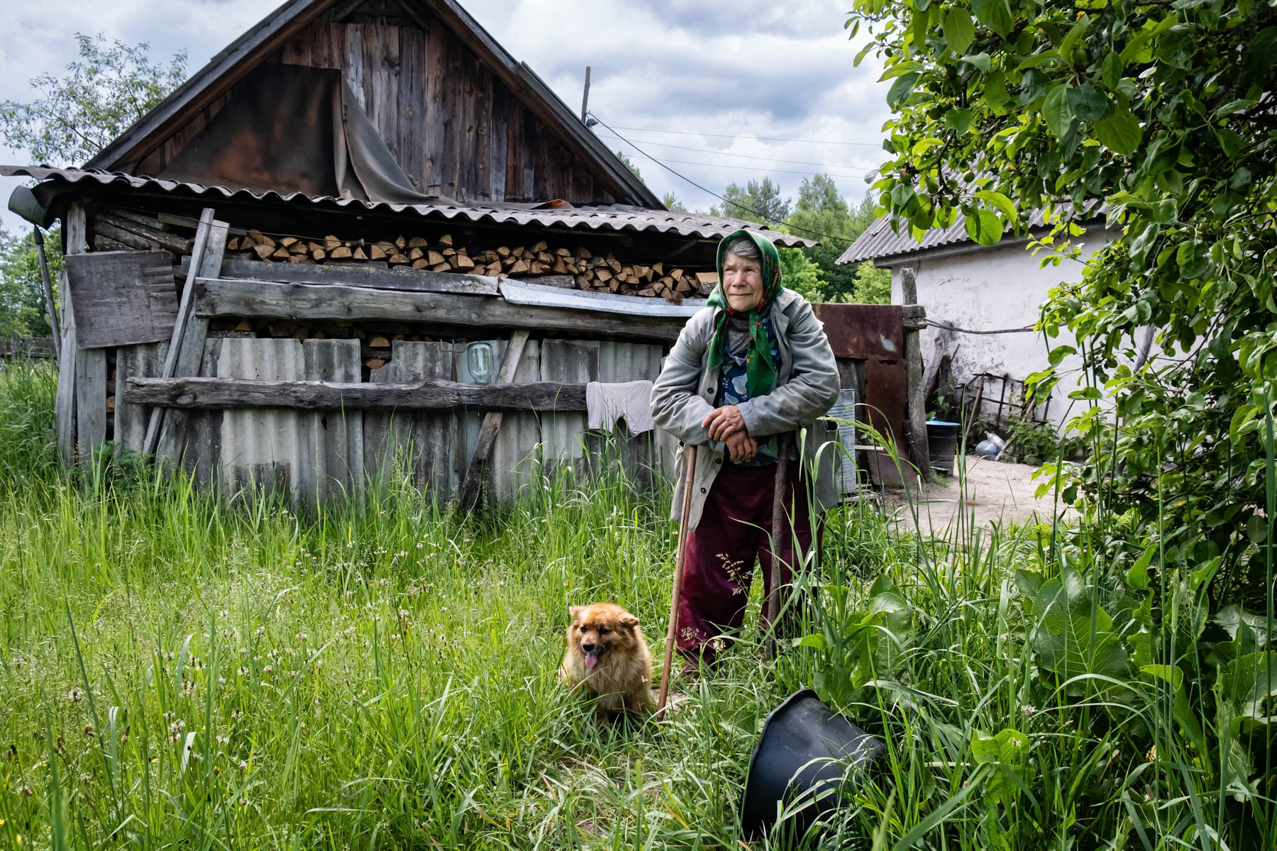 Dunja (Darija), 76 years old, lives alone and takes care of a large vegetable garden. Has problems with her legs and has difficulties to walk. Nearby firefghters help her out when possible.She has no phone in case of emergency because as she says: "I have nobody to call anyway". Dunja is one of the few hundreds of self-settlers that stayed living in the Chernobyl exclusion zone. Paryshiv village, Chernobyl exclusion zone, Ukraine, June 2021