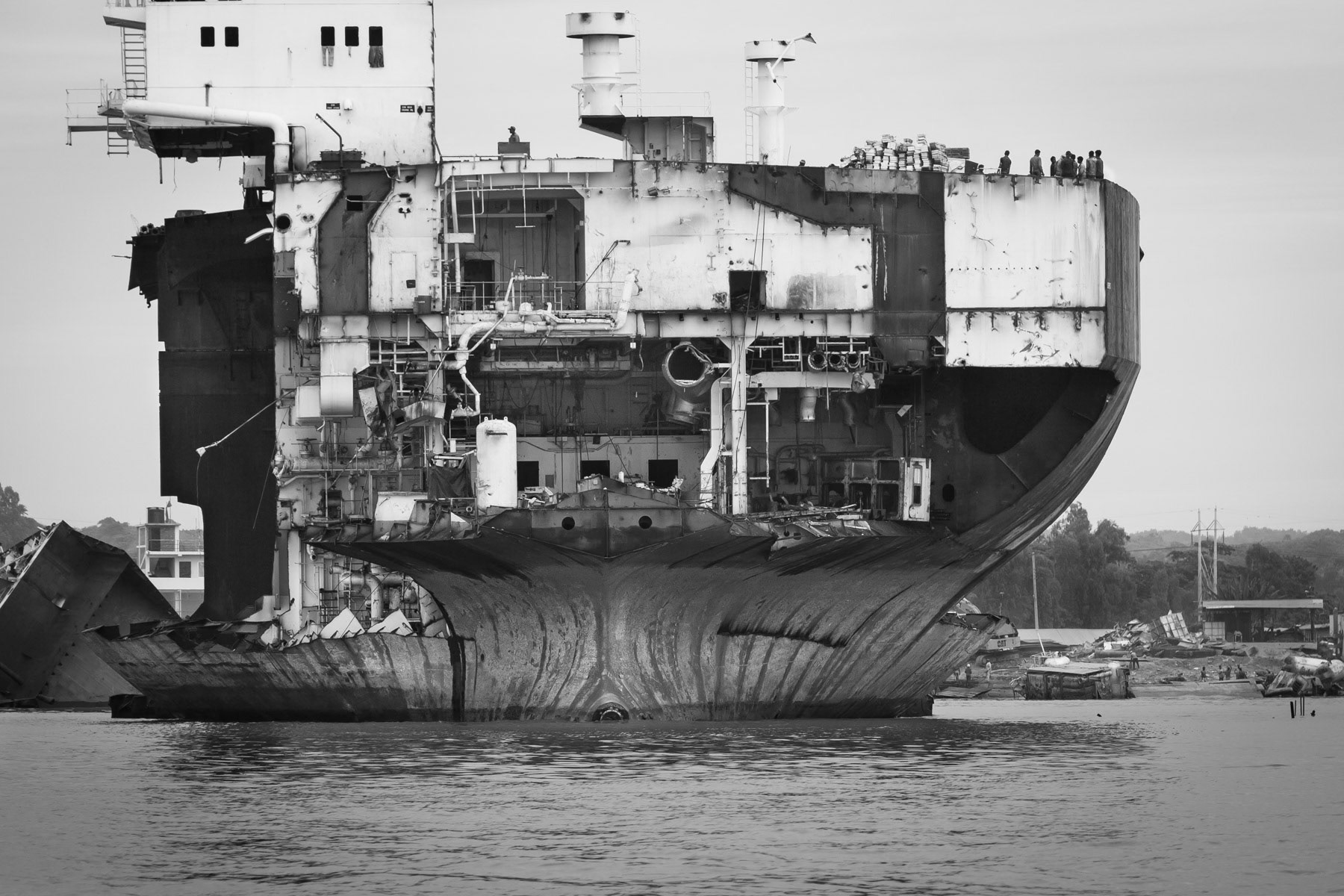 Final dismantling stage. Once the vessel is cut, the larger parts will be further torn apart on the beach before being sold on. Bhatiary ship breaking yards, Bangladesh, October 2014