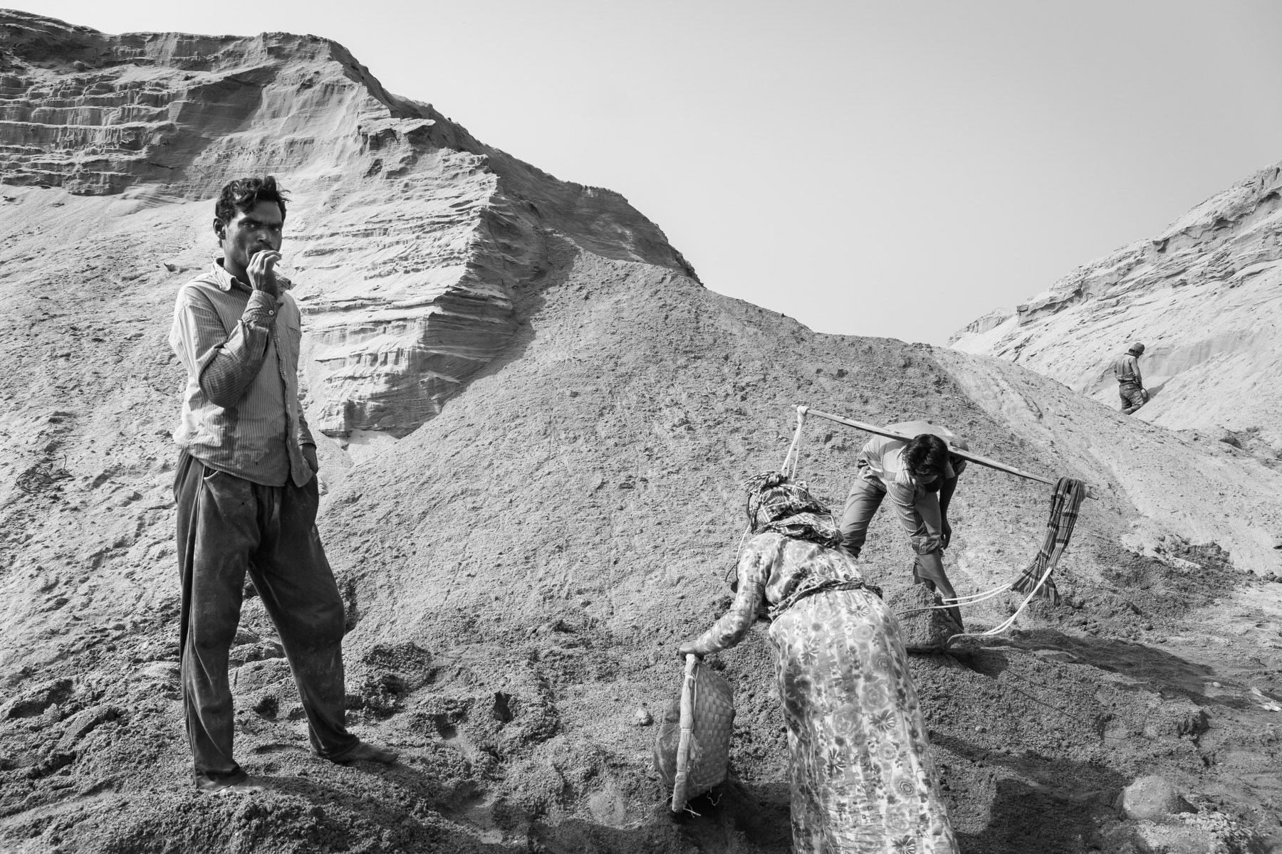 Seasonal workers looking for small stones among the extracted riverbed sand, Jaflong, Bangladesh, December 2015