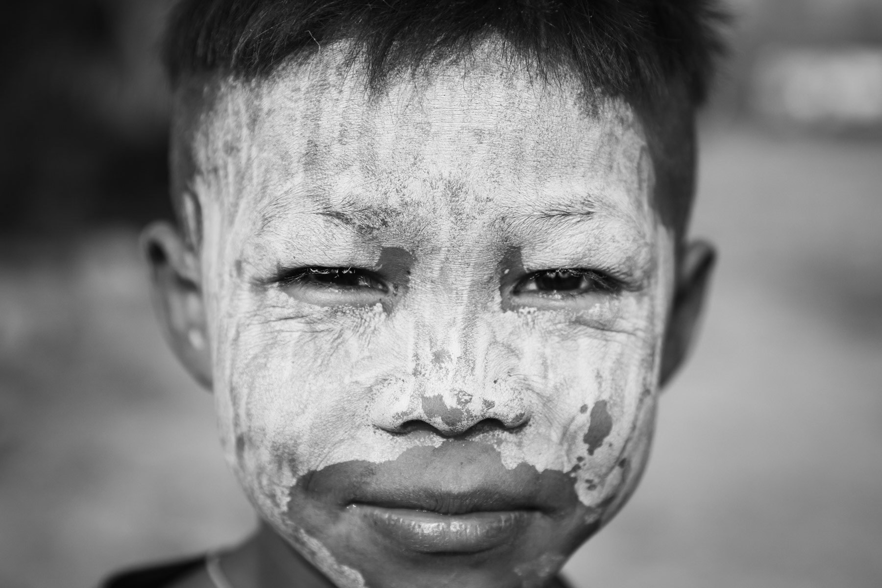 A Karen boy with thanaka on his face. Thanaka is widely used in Myanmar by all ethnic groups to purify and protect the skin. Kayin State, Myanmar, March 2019