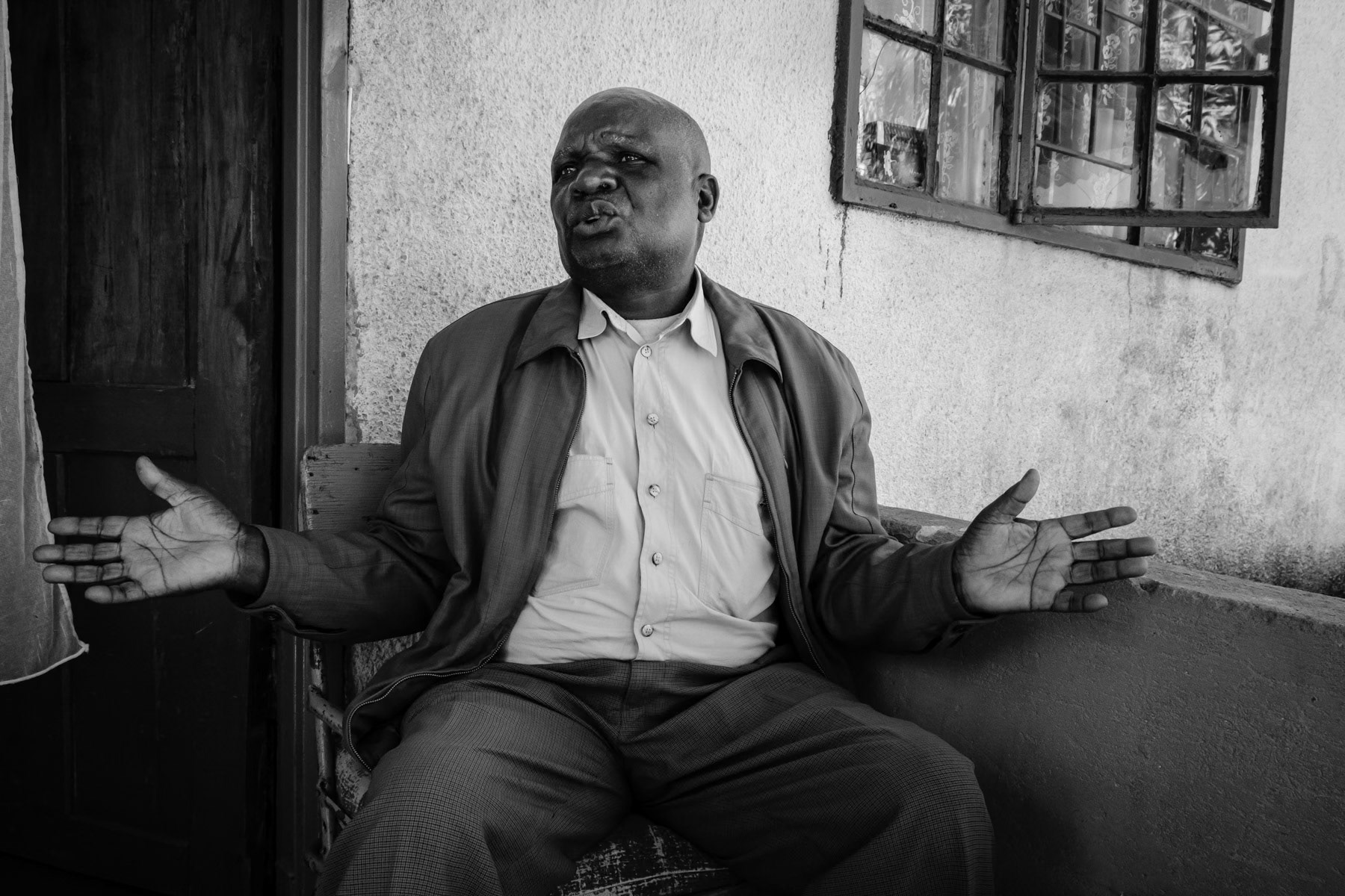 Benson Chimbala Mabiliki, 75 years old, started to work in the Broken Hill mine in 1970. In 1992 he was crushed by a rock while working underground and got severely injured at his spine. Ever since he has been unable to work at the mine or do any hard labour. He has never been compensated for his working accident nor received long term medical help. When the mine was closed in 1994 he was made redundant and could never retrieve his medical file complicating his medical care needs. He still lives with his family in a small house built for the miners working at he Broken Hill mine. Kasanda neighbourhood, Kabwe, Zambia, May 2021