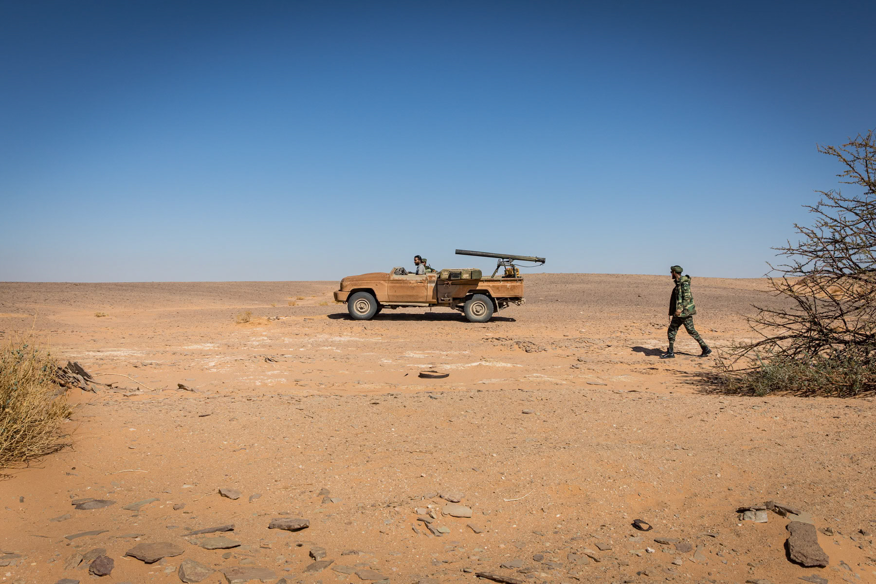 Sahrawi soldiers and a modified mounted 'Grad' rocket launcher preparing to move towards frontline positions near 2,700 km long sand wall, built by Morocco, dividing the Western Sahara between the Moroccan controlled territories and Sahrawi liberated territories. Undisclosed location behind the frontline in the liberated Sahrawi territories, Sahrawi Arab Democratic Republic, October 2021