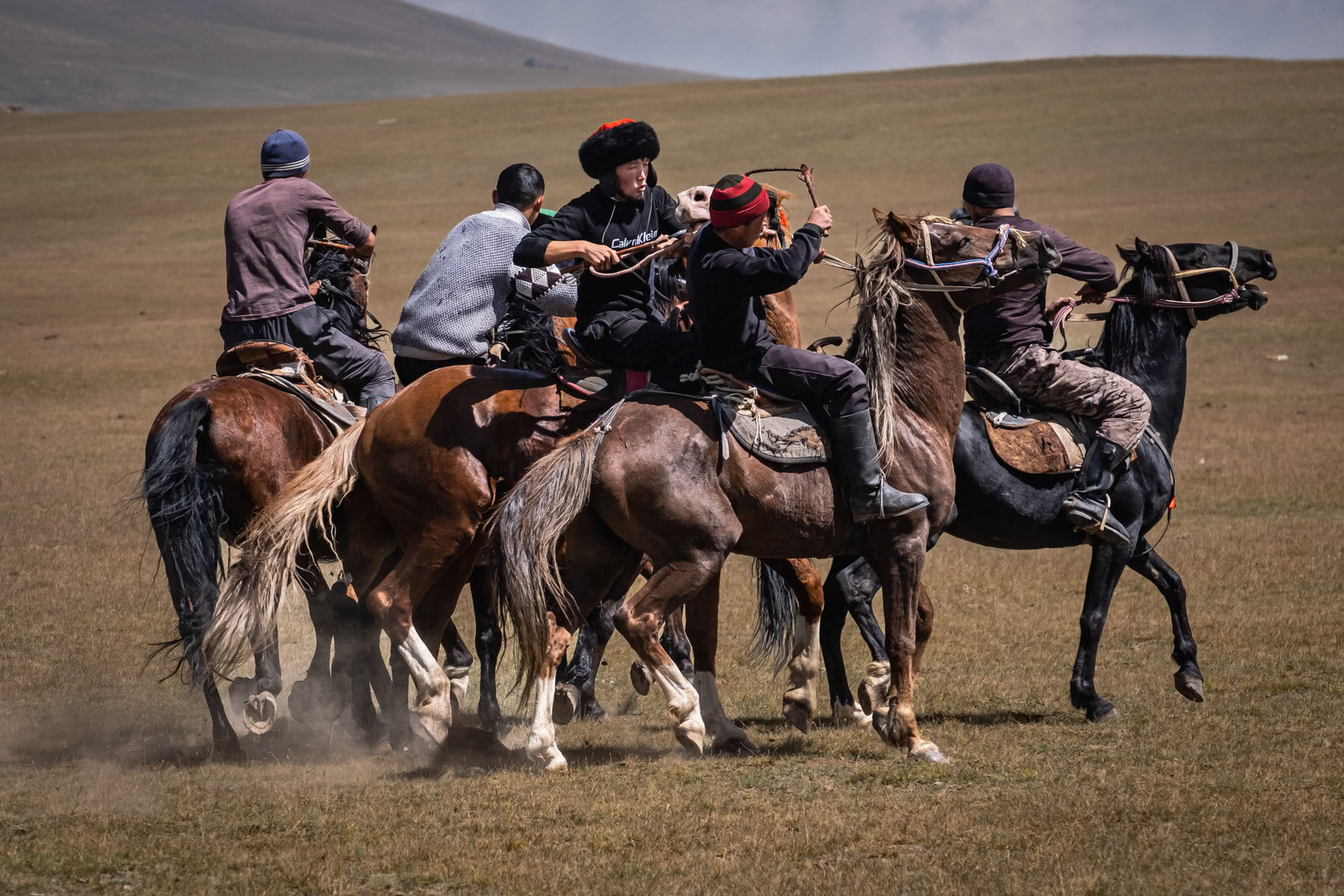 Two teams fighting to take possession of the 'ulak' during a Kok Boru game. The 'ulak' consists of a goat's carcass and needs to be dropped in the opponents' goal in order to mark a point. Son Kul Lake, Kyrgyzstan, August 2021