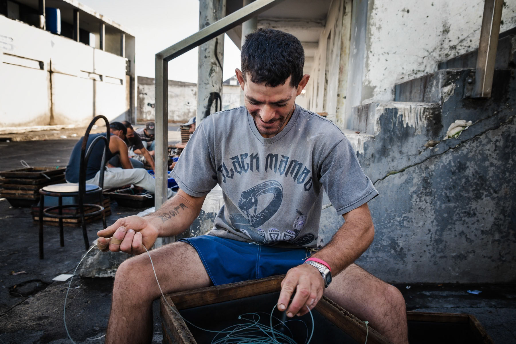 A fisherman preparing his fishing line and verifying the hooks. Rabo de Peixe, Azores, September 2018