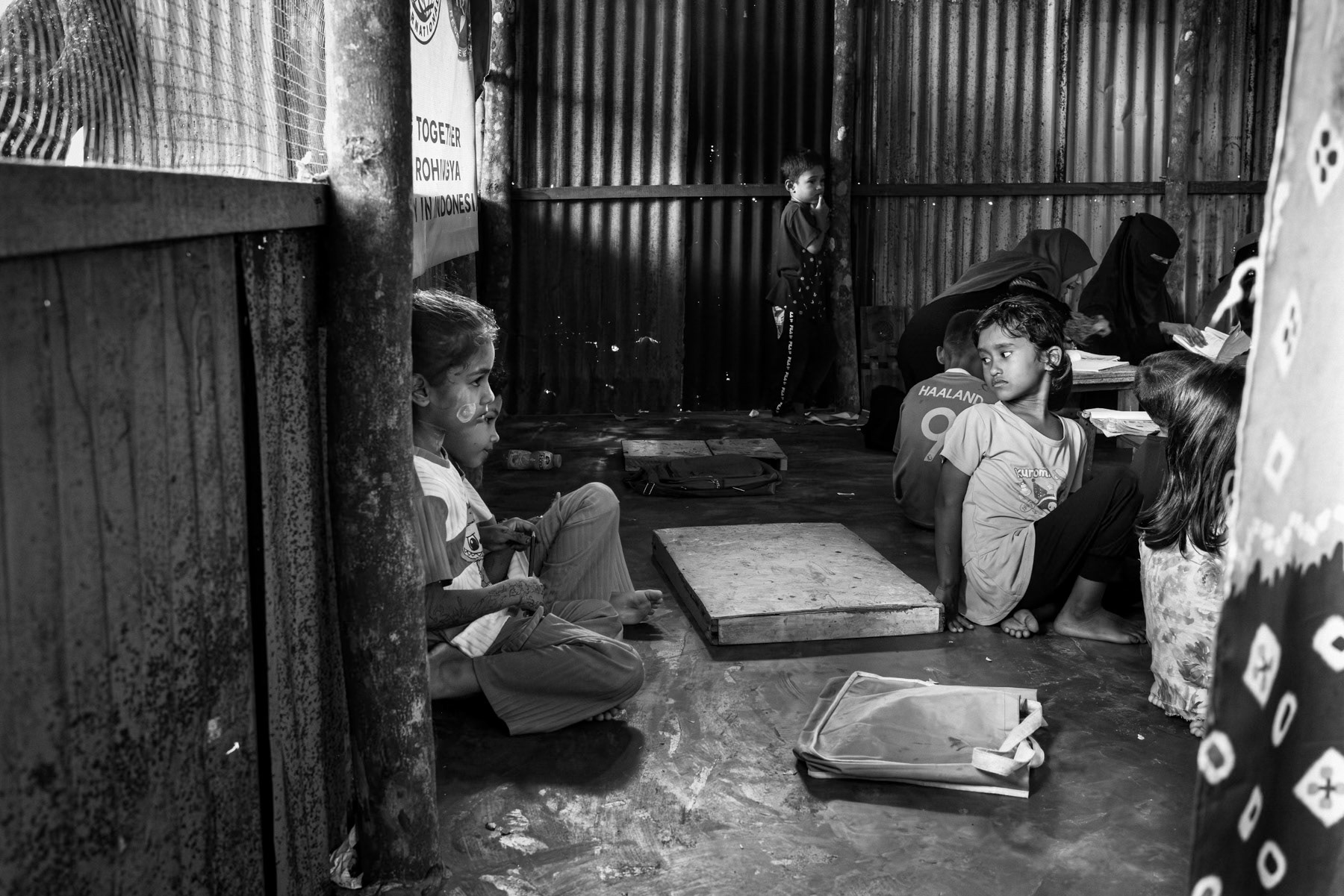 Rohingya girls and women attends a community-run improvised classroom, where volunteers teach basic lessons to boys and girls who are barred from attending local schools. Pekanbaru, Sumatra, Indonesia, October 2025