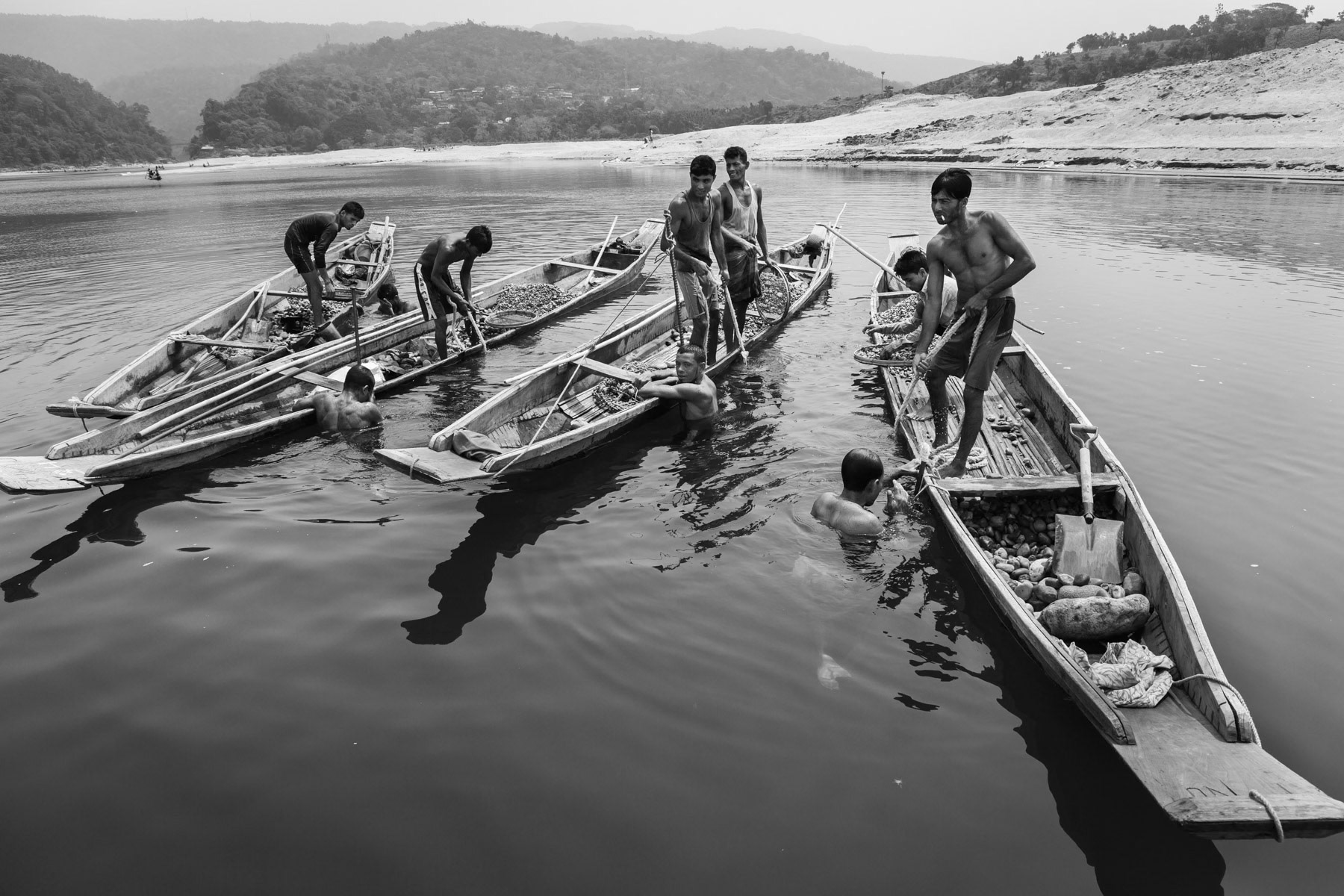 Stone divers recovering stones from the riverbed. Goyain river in Jaflong, Bangladesh, May 2016