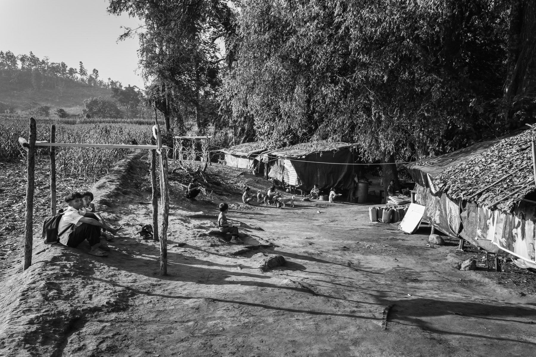 Karen children going to improvised schools along the Thai border. The schools operate in houses or in the open under trees and not in school buildings who are frequently targetted by airstrikes by the military regime. Htee Baw Kaw IDP camp, Kayin State, Myanmar, January 2024