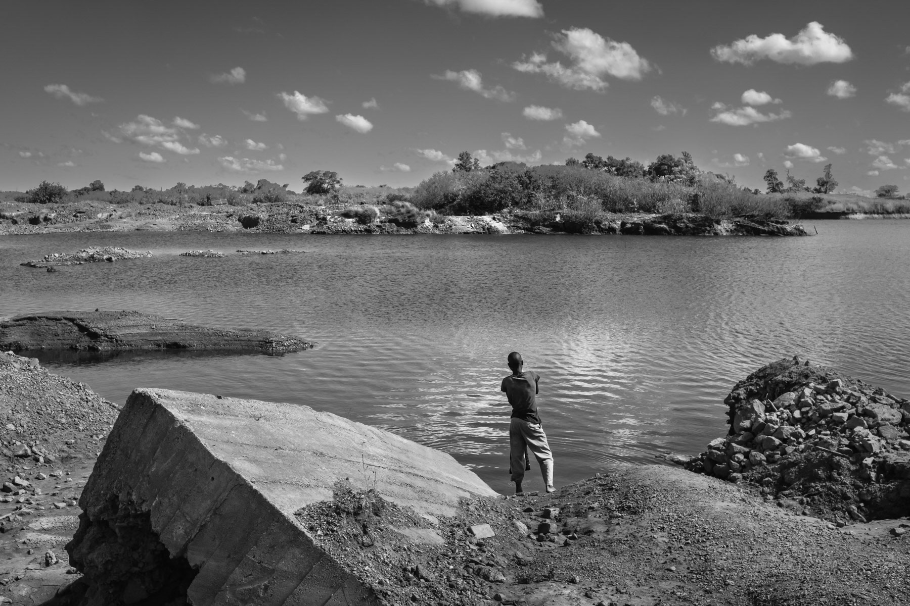 Flooded pithole of the de-commissioned Broken Hill mine. When the lead mine was closed in 1994, many underground tunnels and open pitholes were flooded to restrain access. Nevertheless many small scale mining operations still continue in the suroundings of the mine. Broken Hill mine was one of the largest lead and zinc mine in Africa. Kabwe, Zambia, May 2021