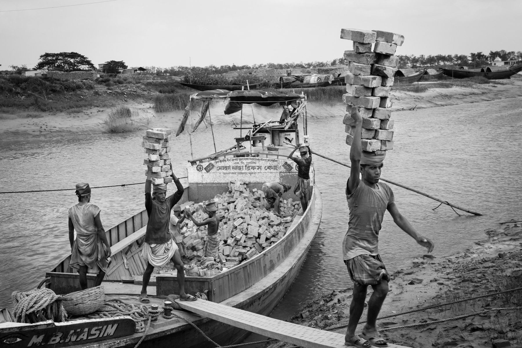 Moving bricks from the brick kiln across the river to the storage place, Koya Bazar brick kiln, Bangladesh, May 2015