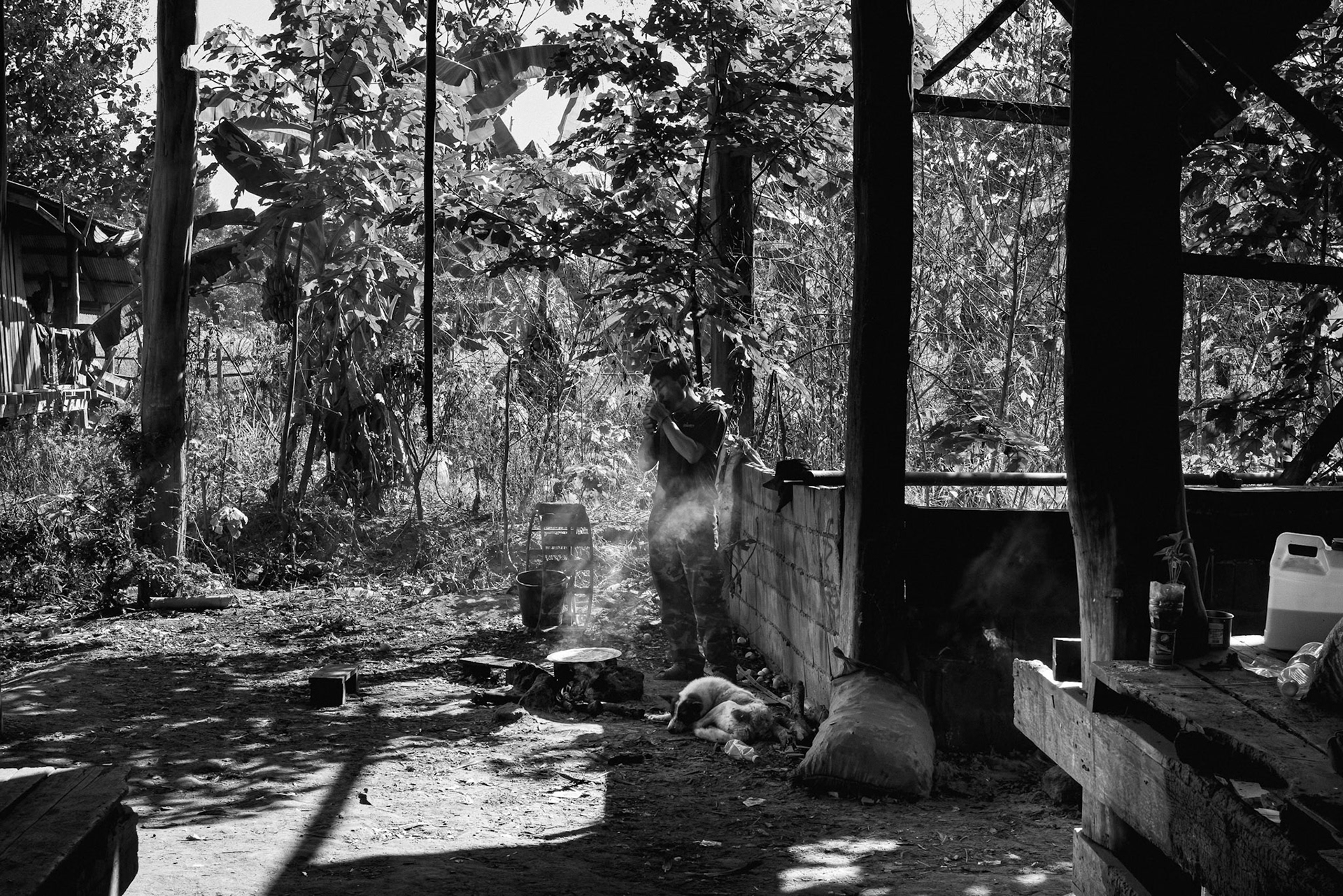 A KNLA soldier at a temporary structure. In Wale, the threat of drone surveillance dictates a life lived largely under cover or within the deep shade of the jungle canopy. Kayin State, Myanmar, January 2026
