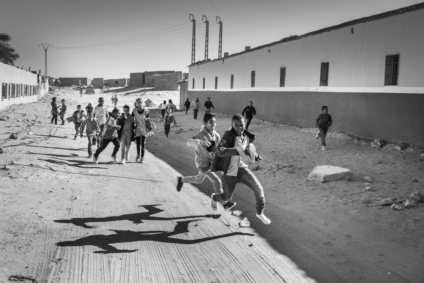 Saharawi children after school. Saharawi refugee camps were established in the seventies in an area managed by the POLISARIO, the government in exile of the Saharawi Arab Democratic Republic (SADR). Between 120 and 150,000 refugees from the Western Sahara live in 5 refugee camps in the desert south of Tindouf. Bojador Refugee Camp, Algeria, December 2019