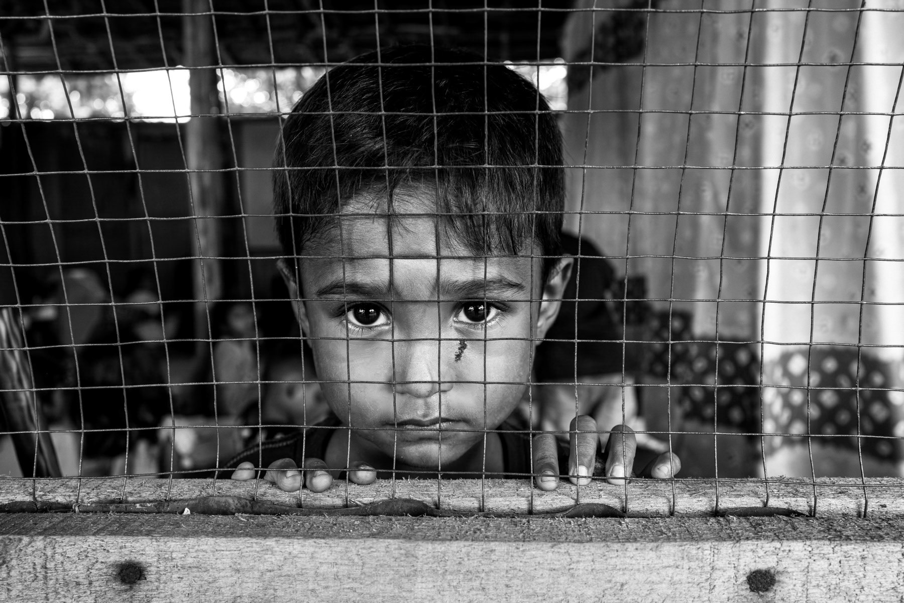 A Rohingya child attends a community-run improvised classroom, where volunteers teach basic lessons to boys and girls who are barred from attending local schools. Pekanbaru, Indonesia, October 2025