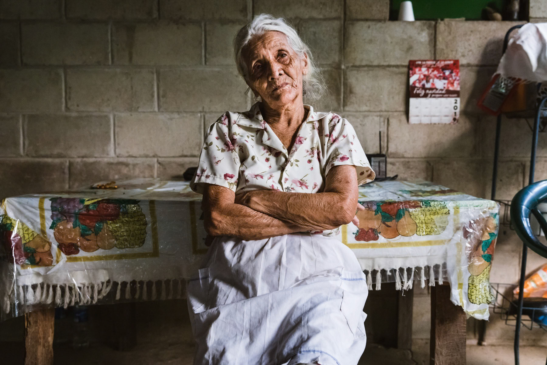 A woman from Arcantao recounting the tough years during the civil war between 1980 and 1992 in El Salvador. The area around Arcatao has been the scene of numerous masacres and war crimes carried out by govrnment dead squads supported by the U.S. The resistence and guerilla had established themselves in the surrounding mountains along the border with Honduras. Arcatao, Chalatenango, El Salvador, April 2019