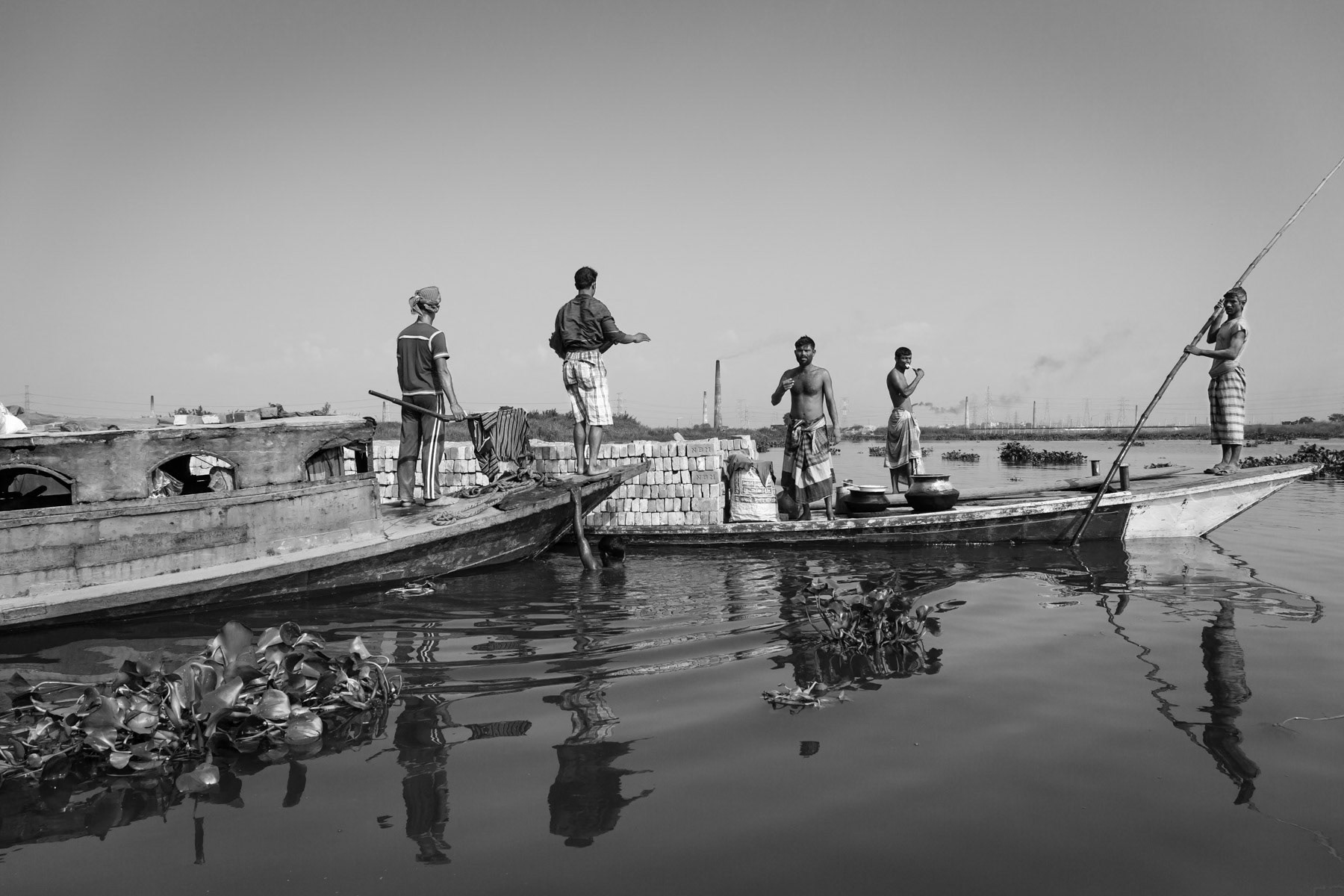 Most of the brick kilns in Amin Bazar are only accessible by boat during the begining of the rainy season. Brick transfer on the Buriganga river to Gabtoli, one of the transport hubs of Dhaka, Bangladesh, May 2015