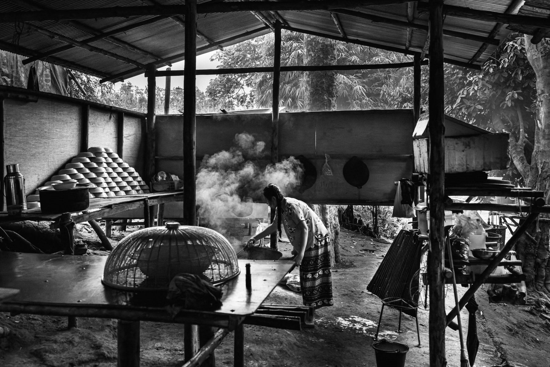 The school kitchen, with formal schools under threat from air and ground attacks, Karen families have relocated their children’s education to makeshift sites near the Thai border, where improvised classrooms provide a fragile sense of safety. Htee Baw Kaw, Karen State, Myanmar, October 2025