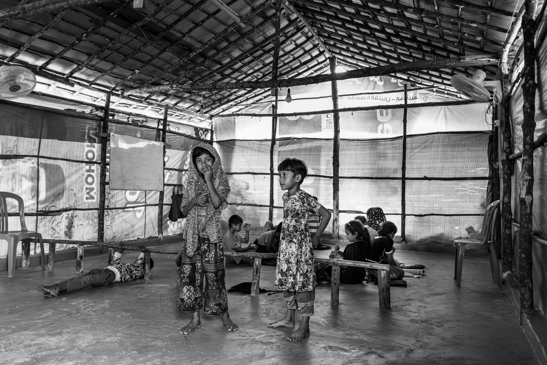 Young Rohingya student takes part in informal lessons organized by the community, offering children a rare chance to learn despite being excluded from local school. Rohingya refugee camp in Pekanbaru, Indonesia, October 2025