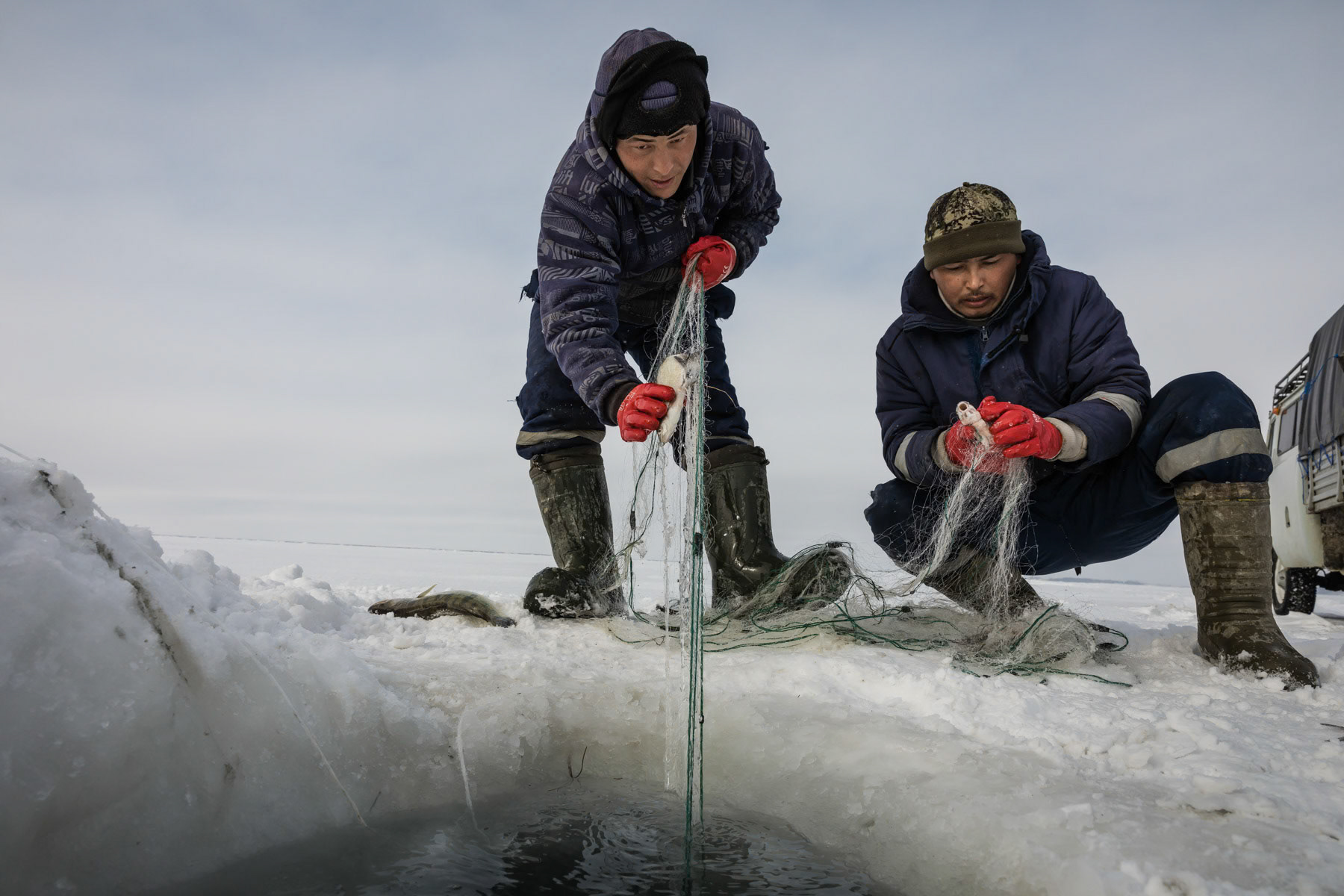 Fishermen at work on the Aral Sea during the ice fishing season. Kazakhstan, January 2019