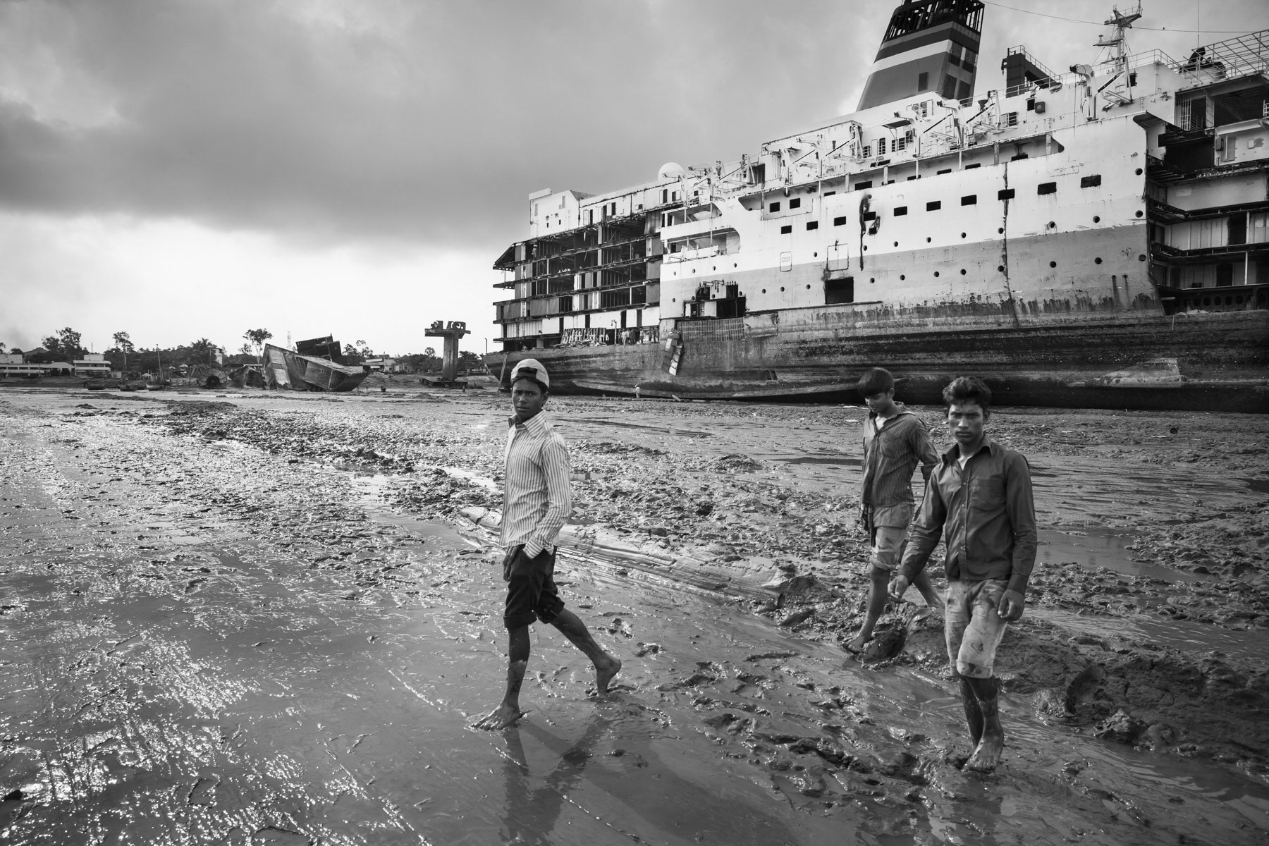 Once the ships are dismantled in large pieces, they will further be cut down by hand to small useable pieces in the adjacent ship-breaking yards. Ship-breaking yard workers, Chittagong, Bangladesh, June 2015