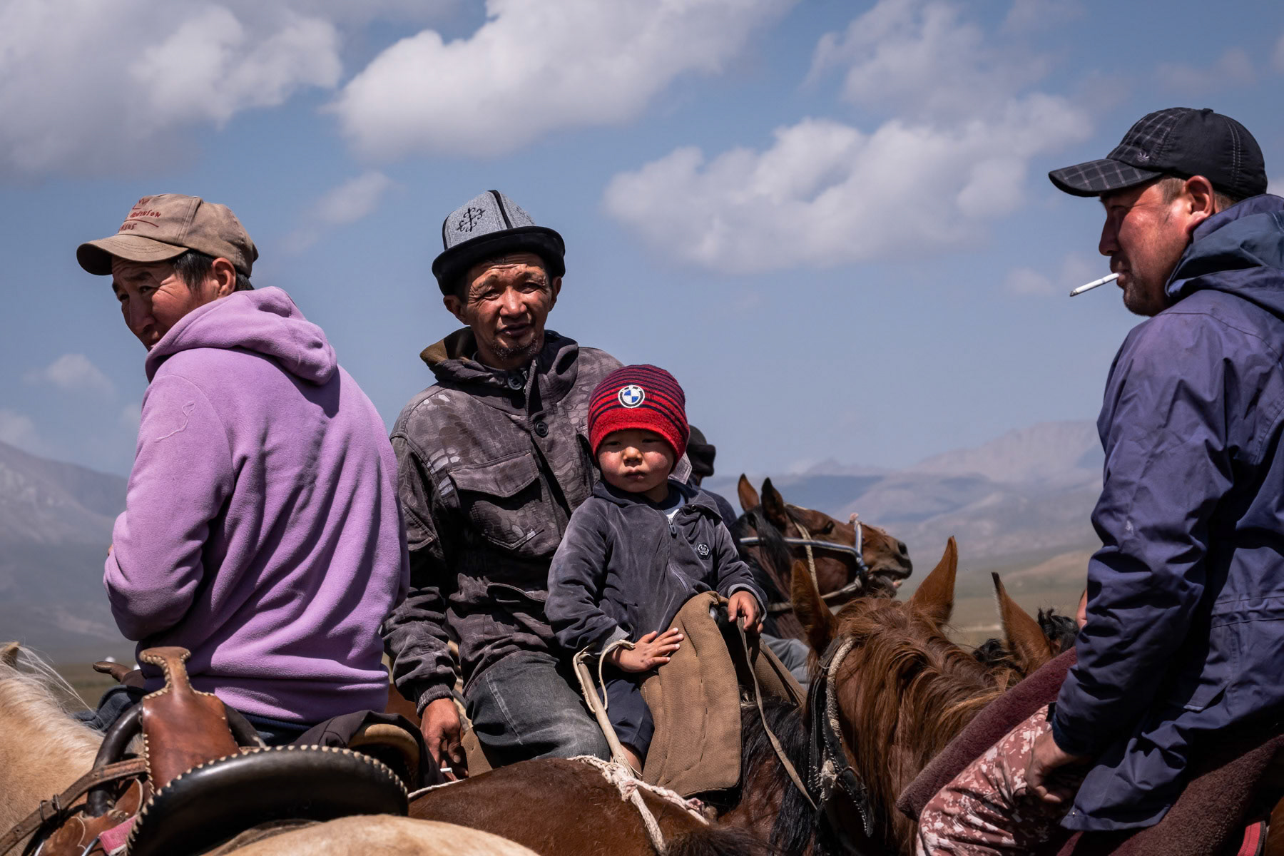 Younger and older spectators of a Kok Boru horseback game, Son Kul Lake, Kyrgyzstan, August 2021