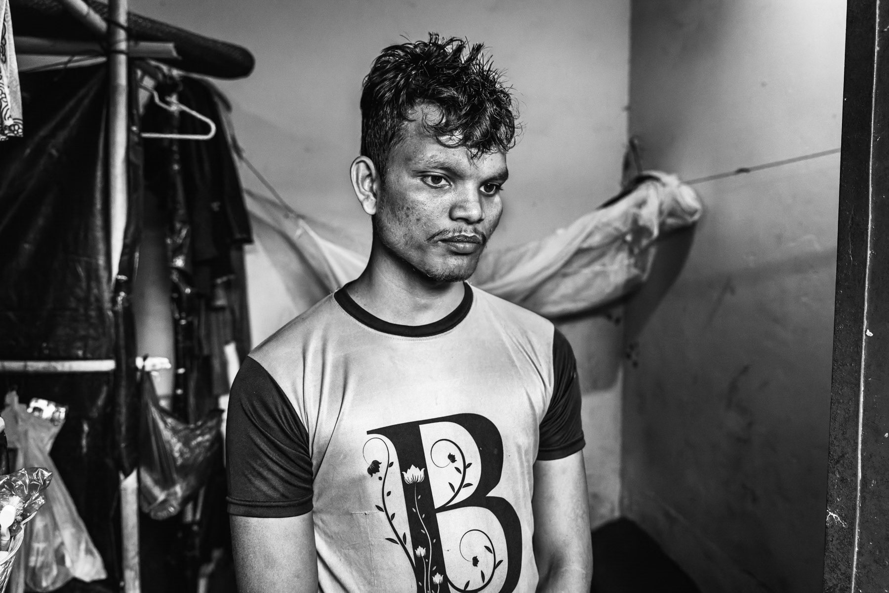 Umar Farooq, from Shida Para in Maungdaw, stands after being seriously injured in the leg by drone shrapnel fired from Arakan Army positions near the Naf River while fleeing Myanmar with his younger sister on 7 August 2024. He arrived in Bangladesh on 8 August 2024, where he received medical treatment. Umar was a student before being forced to flee by the Arakan Army. Kutupalong refugee camp, Ukhiya, Bangladesh, September 2025