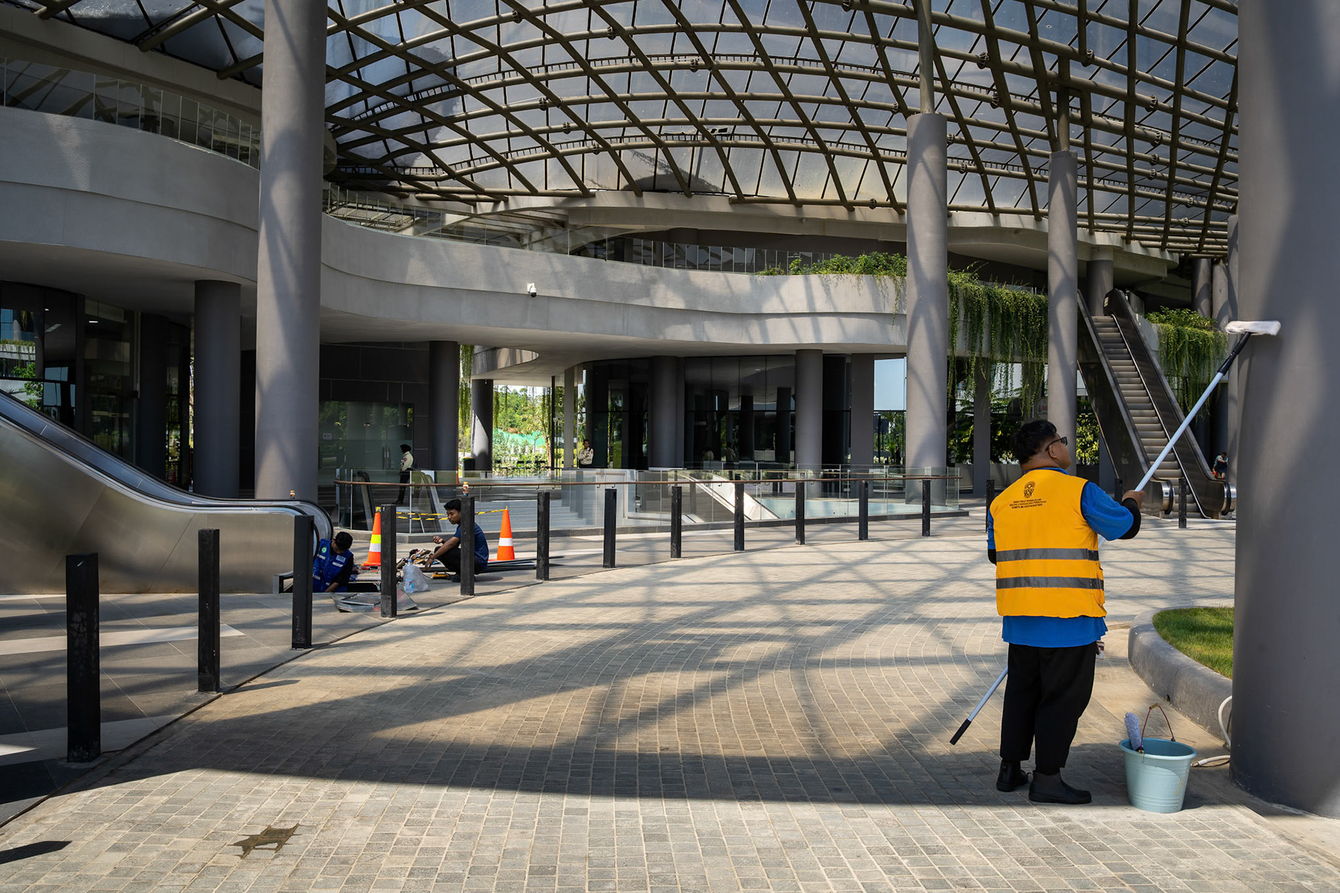 A lone security guard stands watch over a silent interior—currently one of the few "residents" in a city designed for millions, as construction crews wait for a budget that may never arrive. Ibu Kota Nusantara (IKN), Indonesia, January 2026