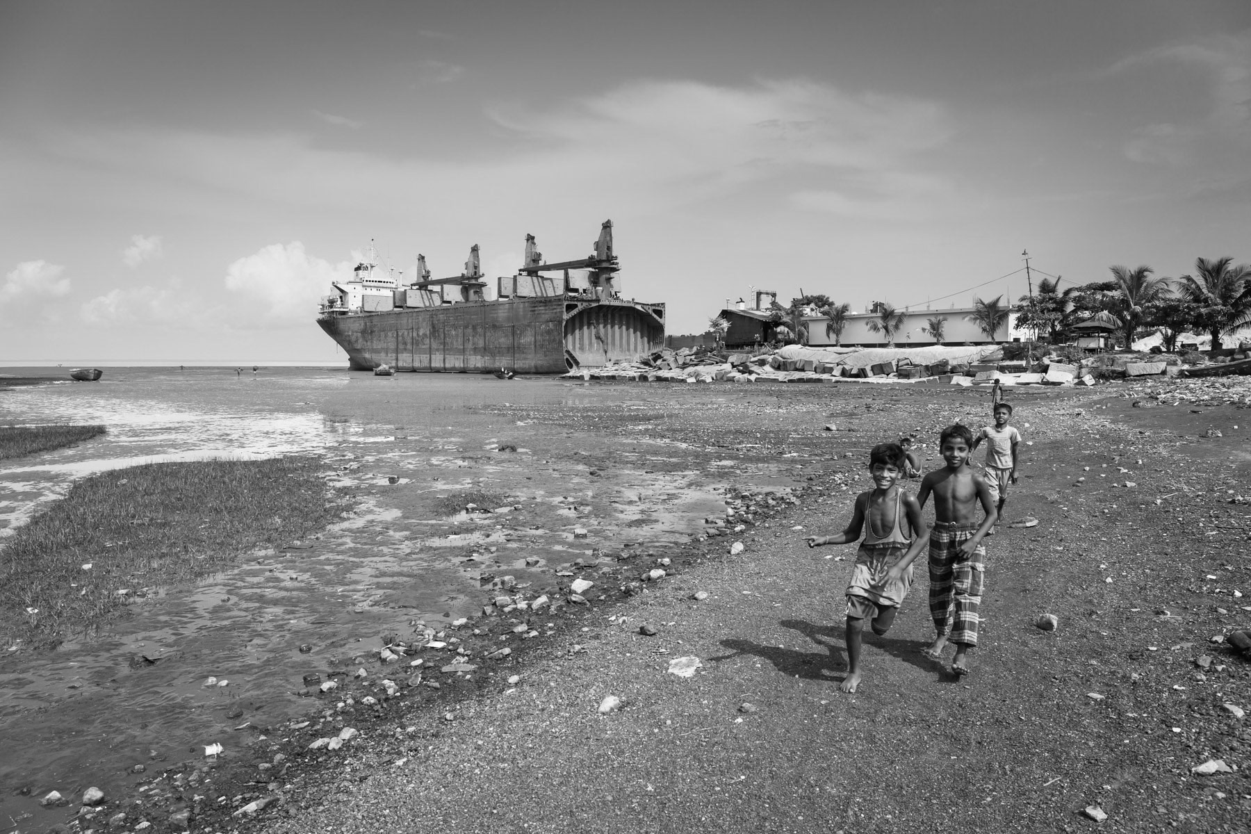 Access point between ship-breaking yards. Due to the expansion of ship-breaking yards, local communities living along the shore have been slowly cut off from the sea, their main source of income. Kumira, Bangladesh, June 2015