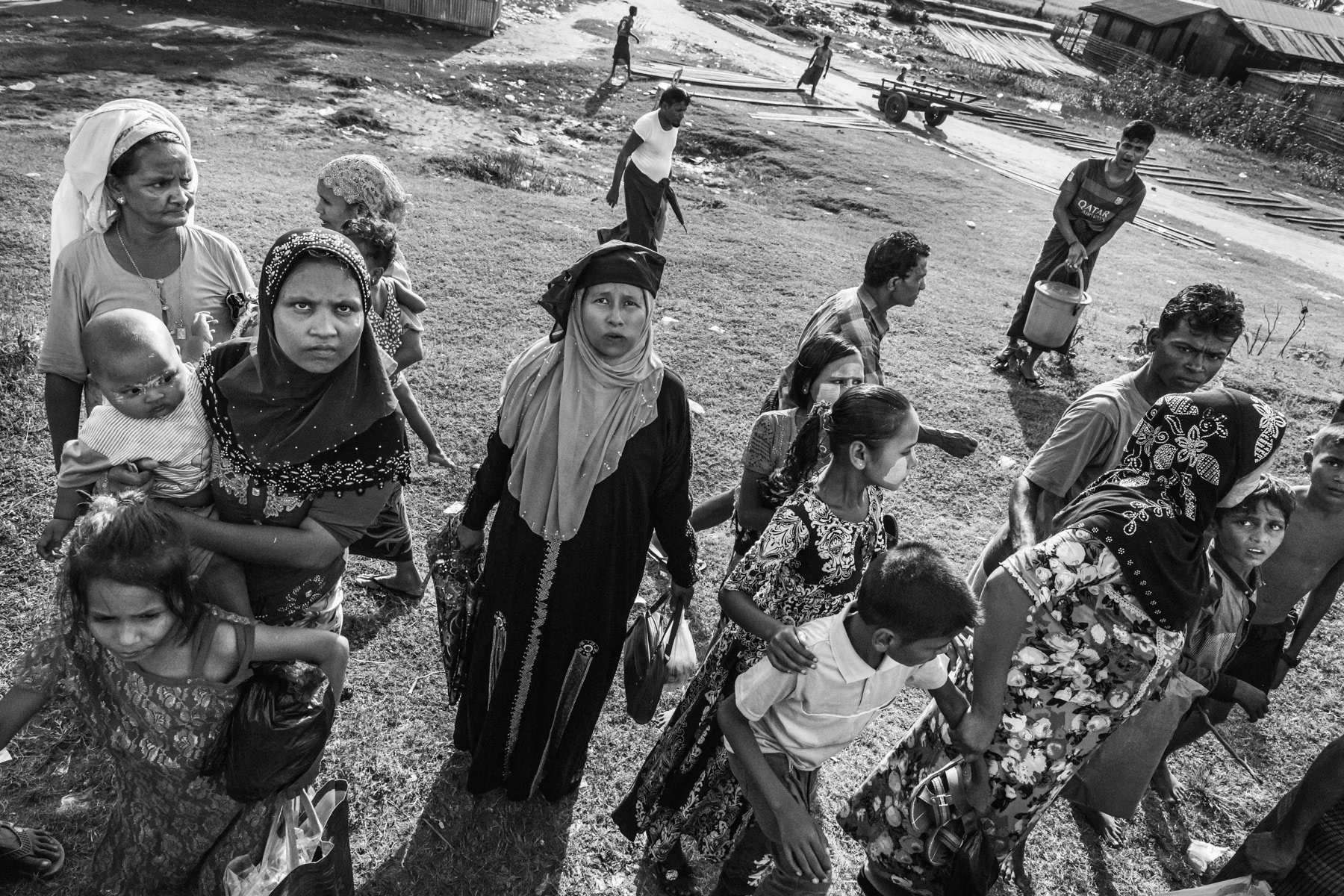 Two years after Myanmar's military brutal campaign against the Rohingya, which led to the exodus of more than 750,000 people and sustained accusations of genocide, an important number estimated between 500 and 700,000 stayed behind in Rakhine. Mainly concentrated around Sittwe and other townships in central and southern Rakhine. Their situation is becoming worse since hamanitarian aid is severely restricted, a new ethnic conflict has erupted in Rakhine and the attention of aid agencies have been mainly focussing on the Rohingya that fled to Bangladesh in 2017. Their movements are further severely restricted allowing them to circulate within the camps and surrounding Rohingya villages. A train that passes through the villages and camps twice a day remains the only affordable transport between the IDP camps on the outskirts of Sittwe, the capital of Rakhine. Rohingya villagers travelling by train to the IDP camps where 130,000 Rohingya have forcibly be settled since 2012. Sittwe township, Rakhine, Myanmar, September 2019