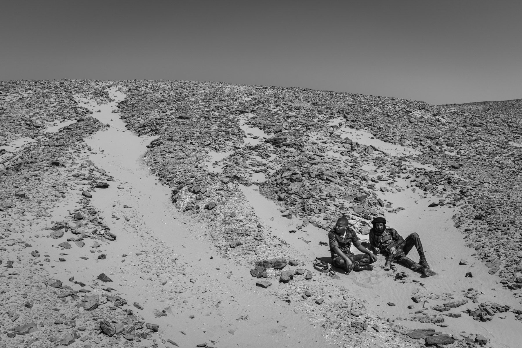 Sahrawi military drivers out of their vehicles in case of drone attacks waiting to transport back military staff from a frontline position. Undisclosed location in the liberated territories of the Western Sahara, October 2021