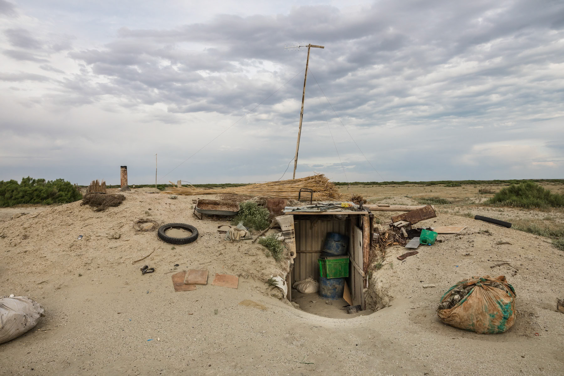 Underground shelter for fishermen used to store things and rest in the summer and to live several days in the winter when road conditions are too difficult and when the ice season starts. Tastubek, Aral Sea, Kazakhstan, June 2019