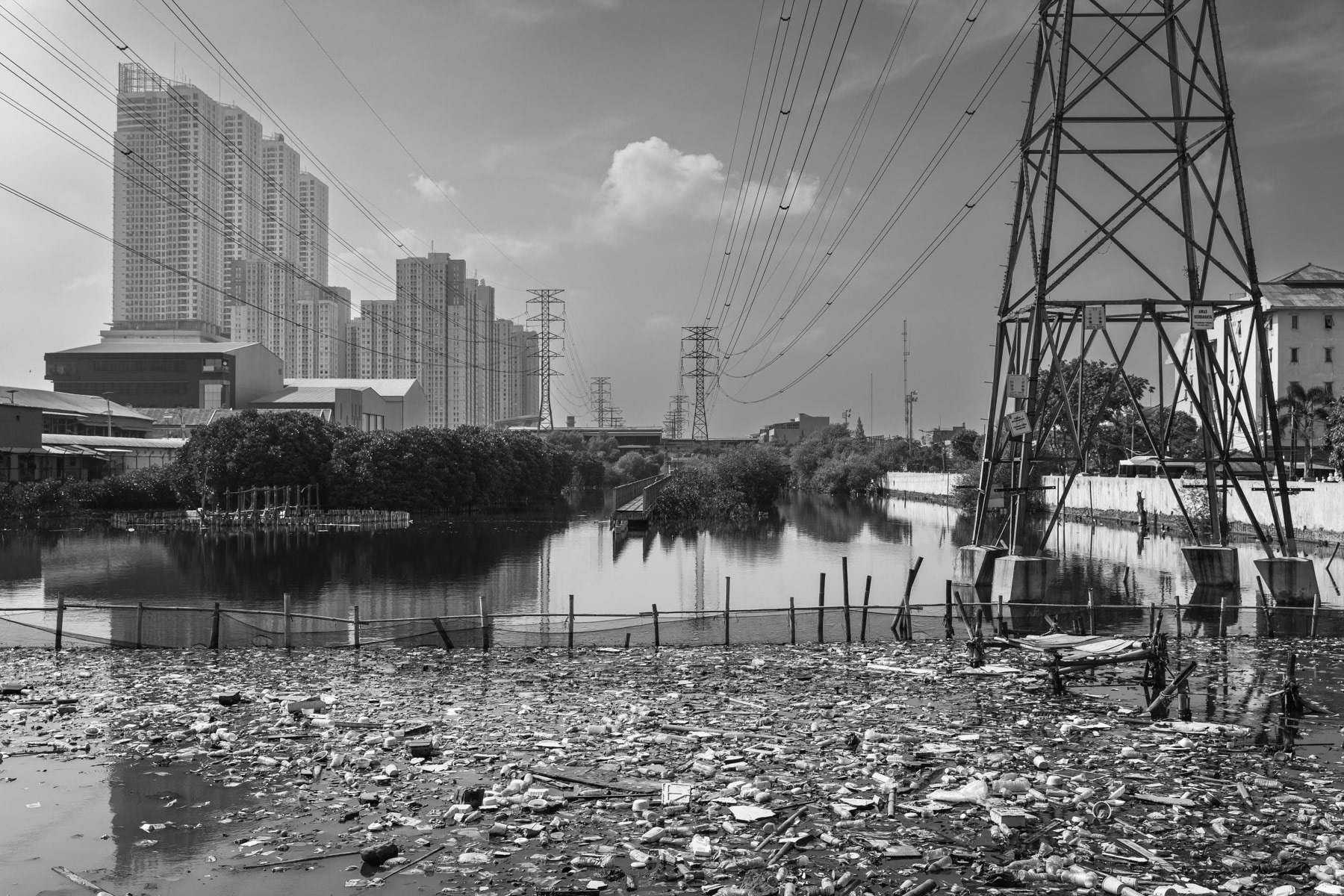 Real estate development project have a very nefast environmental and social impact, such as blocking natural river outflow, depleting drinking water reserves provoking soil sinking, changing sea currents affecting fish reserves, and evictions within the poor coastal communities. Muara Angke, Jakarta, Indonesia, June 2022