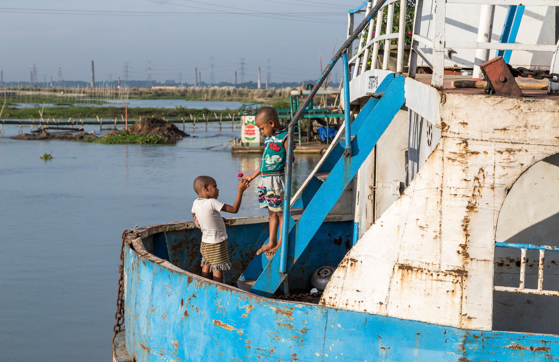 Children on a cargo ship along the Buriganga river, industrial zone between Hazirabagh and Gabtoli, Dhaka, Bangladesh, October 2014