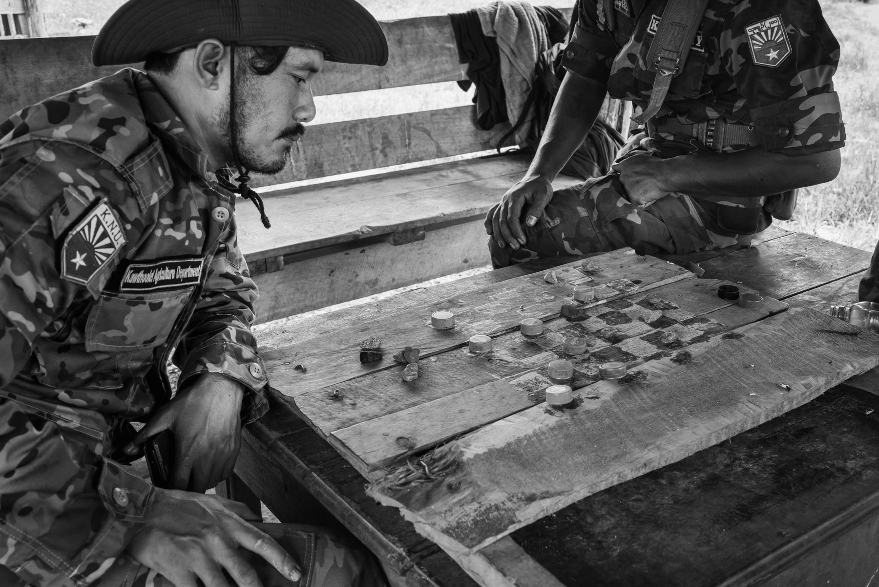 Soldiers of the Karen National Liberation Army plying a board game in their field camp near a combat zone around the town of Walay in Karen State, Myanmar, October 2023